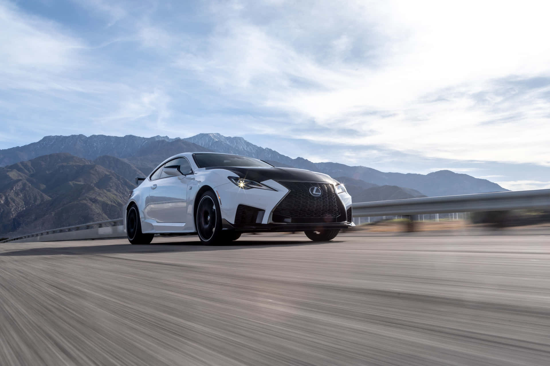 The Lexus Rc F Sports Car Driving On A Mountain Road Wallpaper