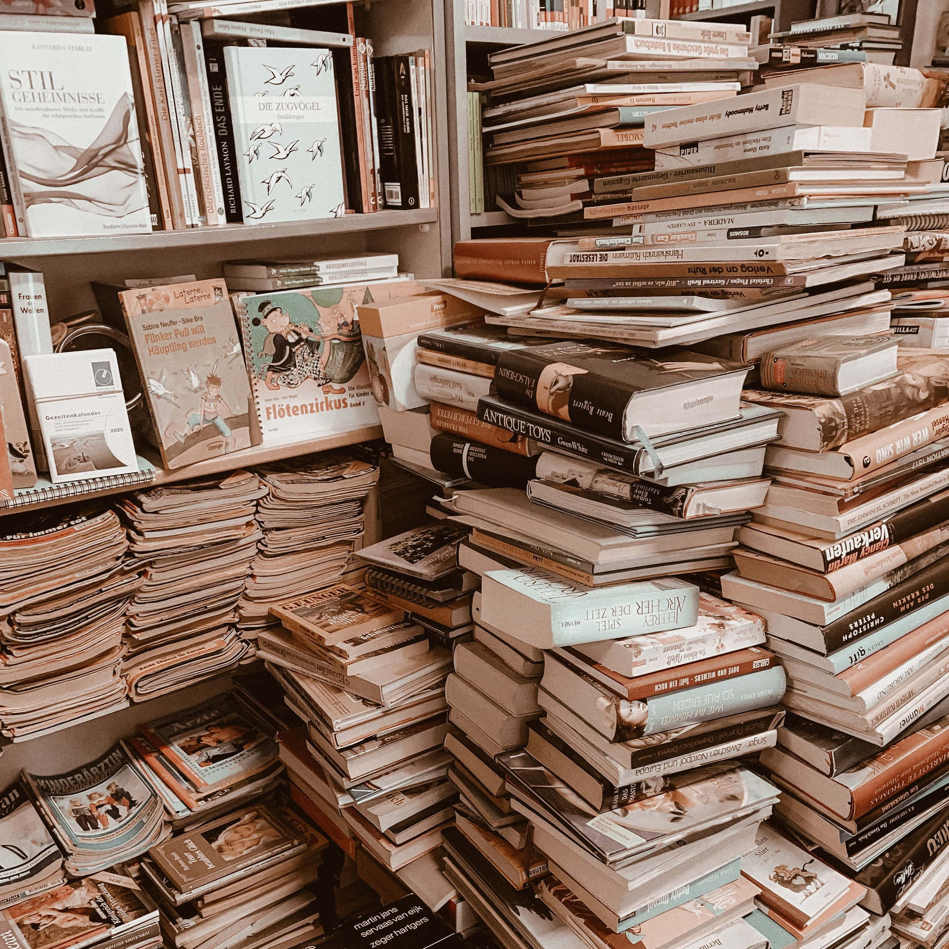 A Pile Of Books On A Shelf