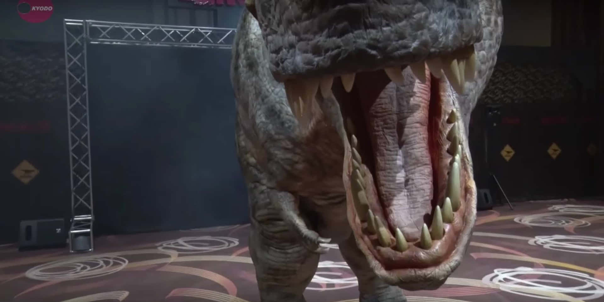 a t - rex with its mouth open in a room