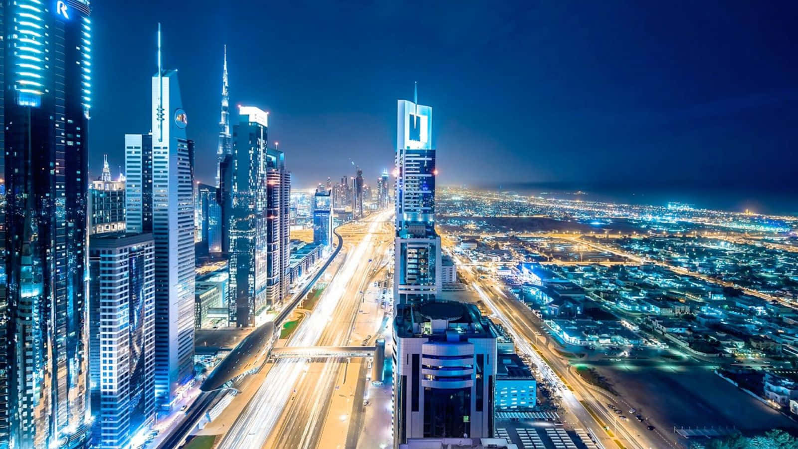 A Cityscape At Night With Lights And Traffic