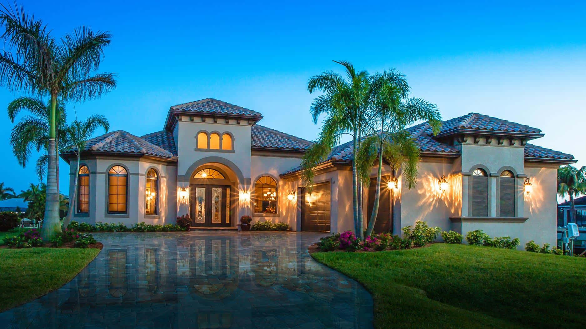 A Beautiful Home With Palm Trees And A Driveway