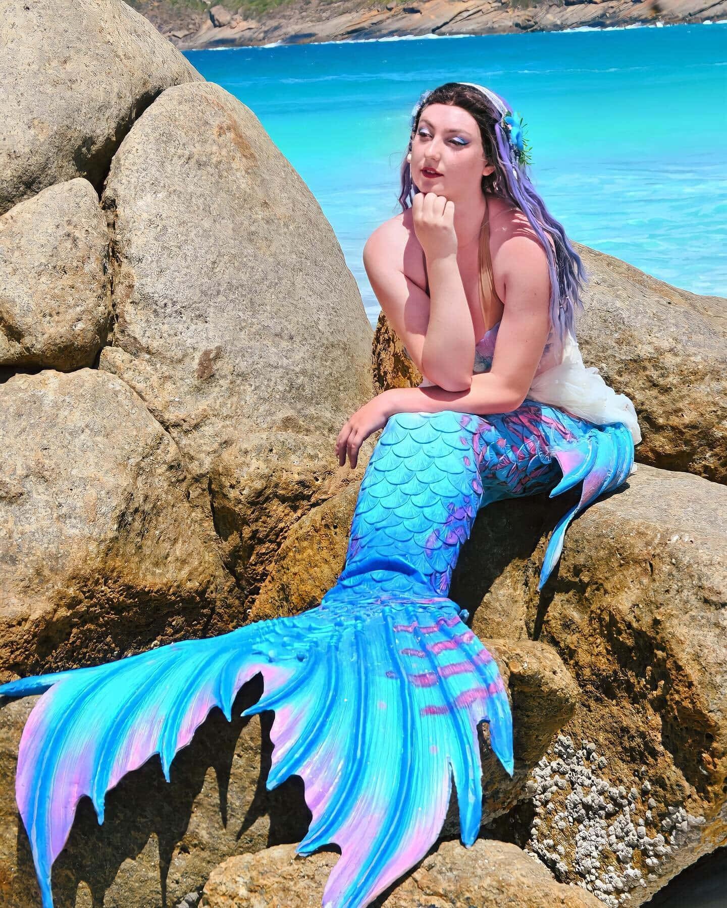 A real-life mermaid's sparkling tail glimmering in the sun.