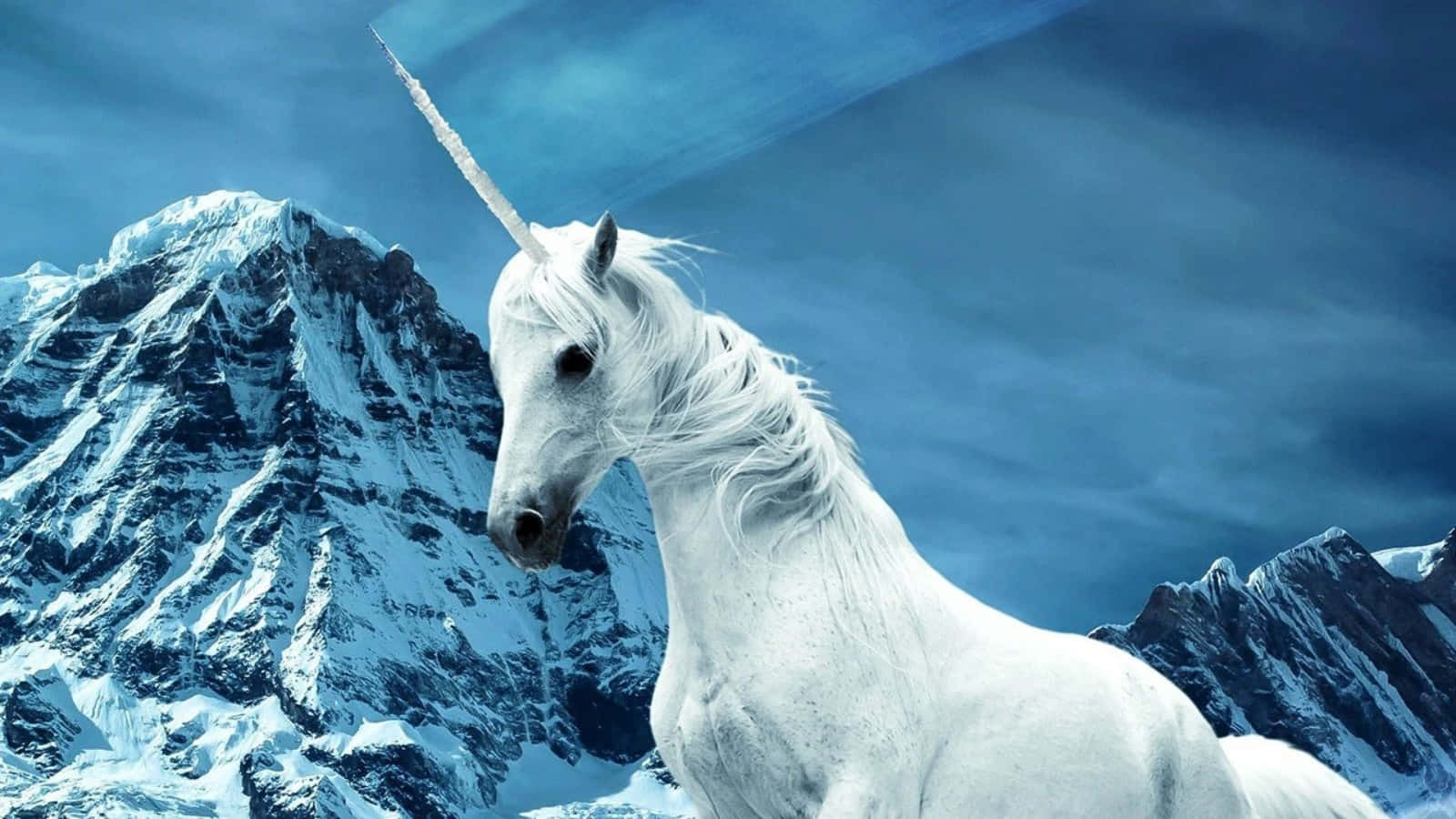 A White Unicorn Standing In Front Of A Mountain