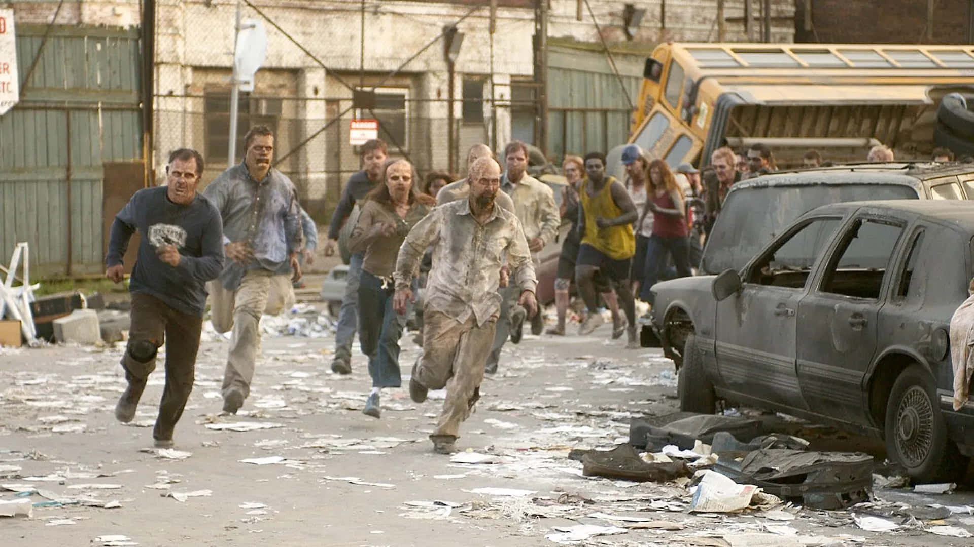 the walking dead season 3 - a group of people running through a city