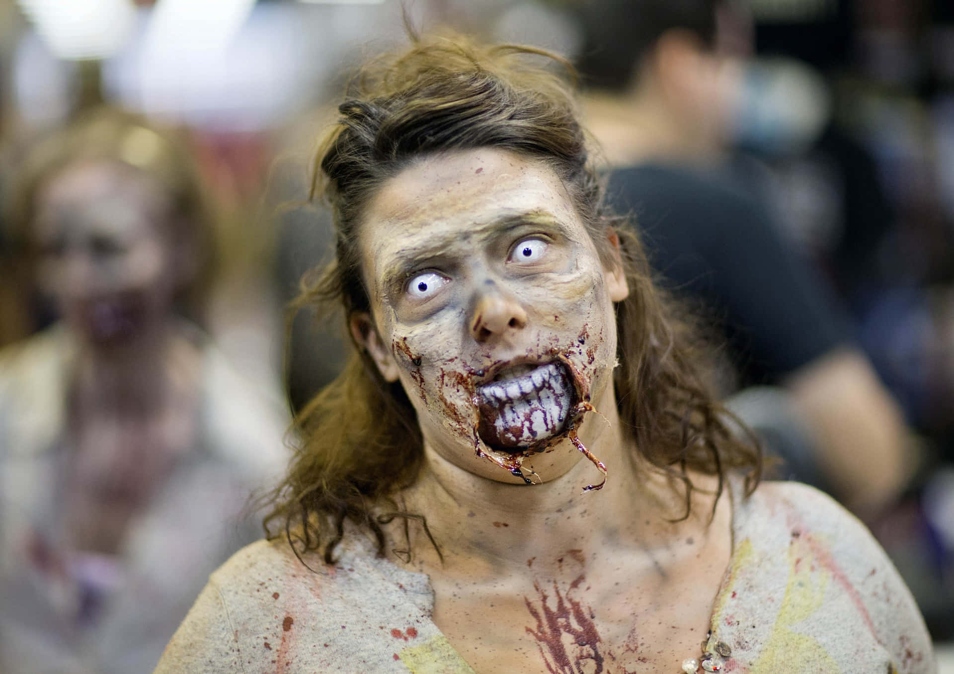 a woman dressed as a zombie in a convention