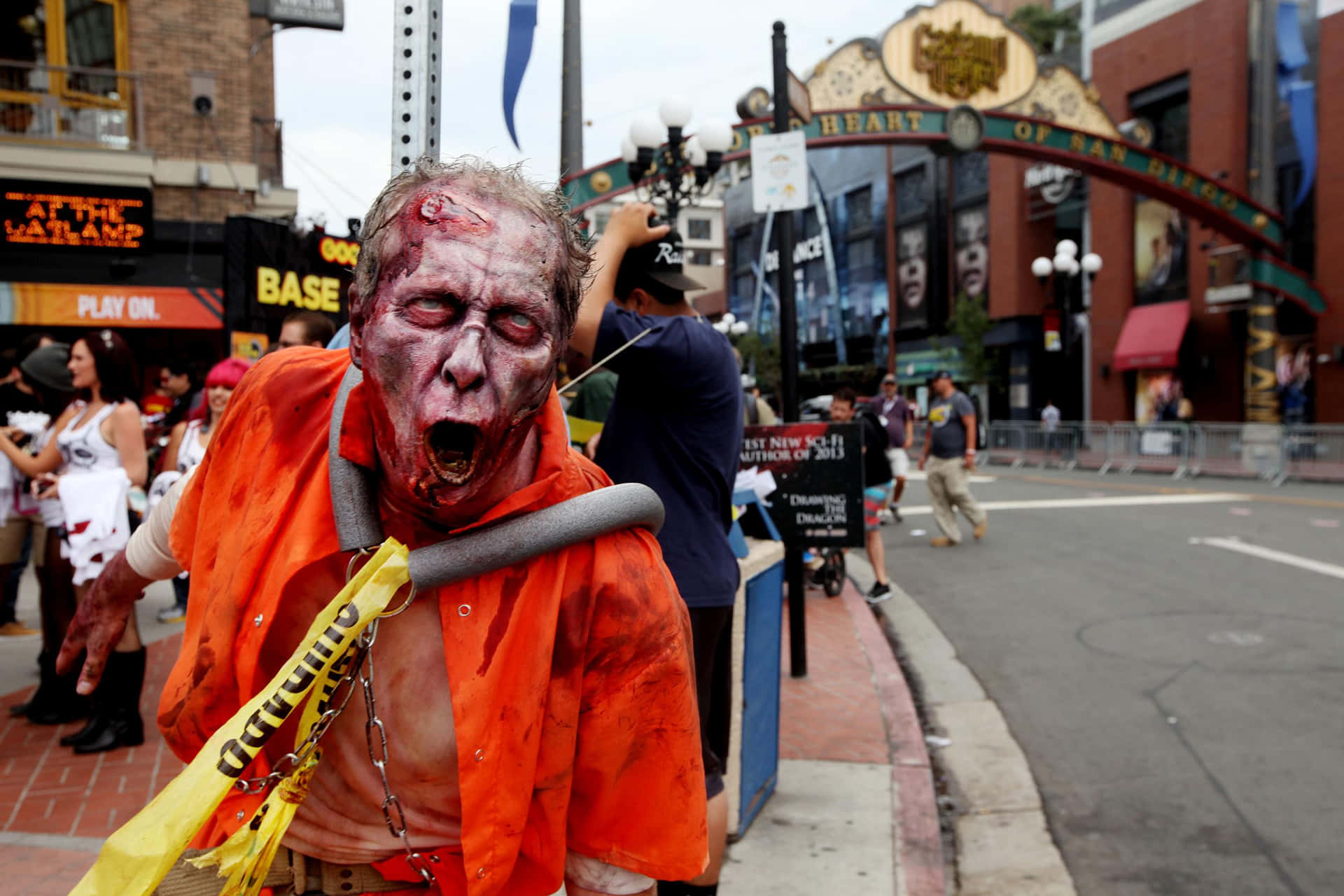 a zombie dressed in orange and yellow is walking down the street