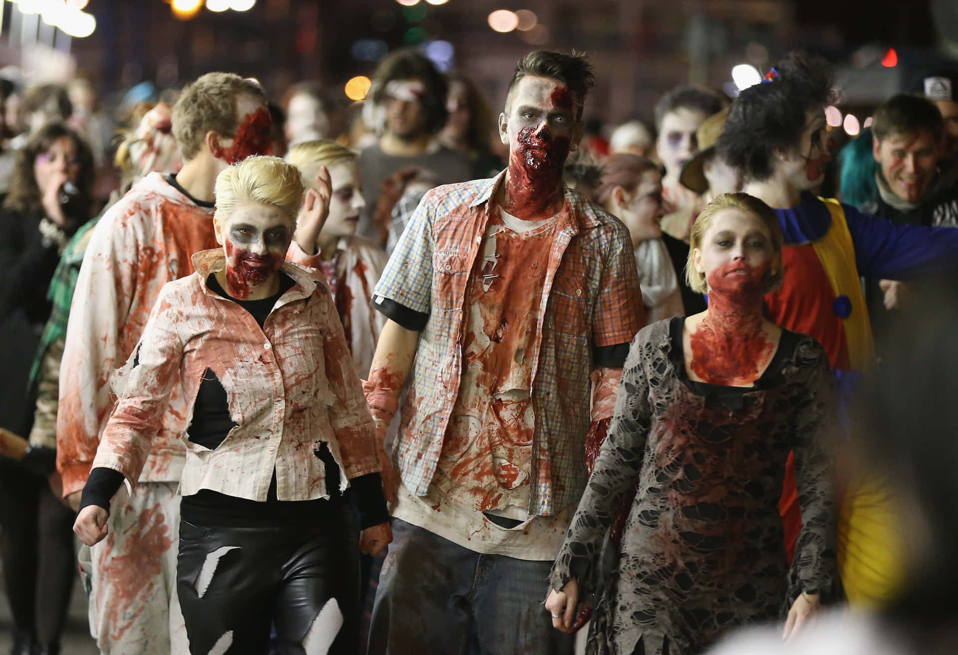 a group of people dressed up in zombie makeup walking down the street