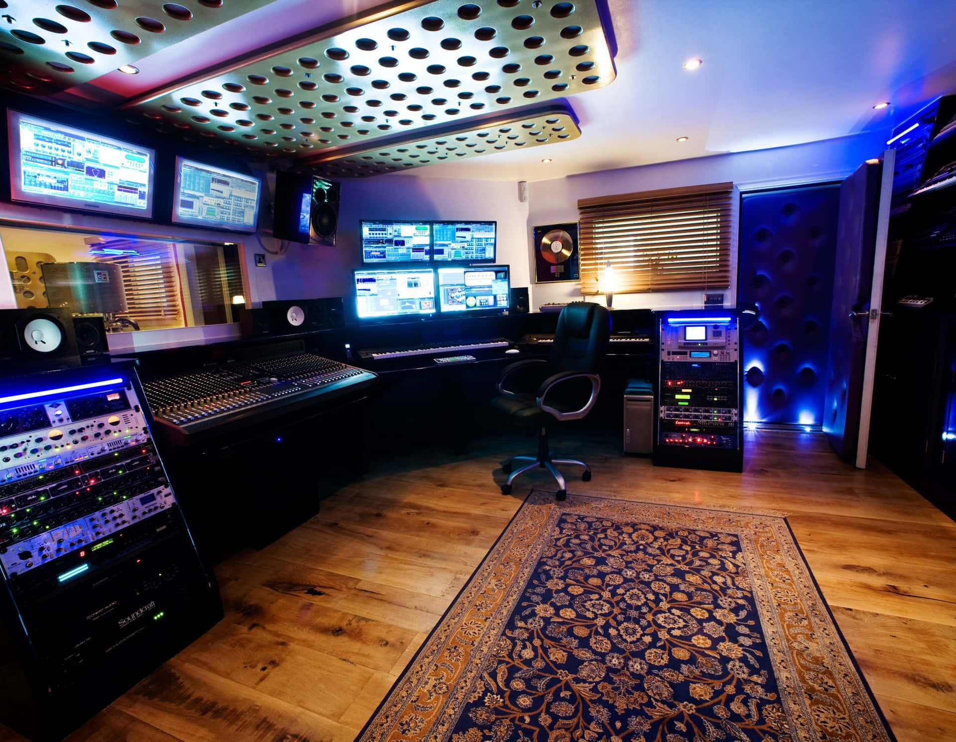 A Recording Studio With A Large Monitor And A Keyboard