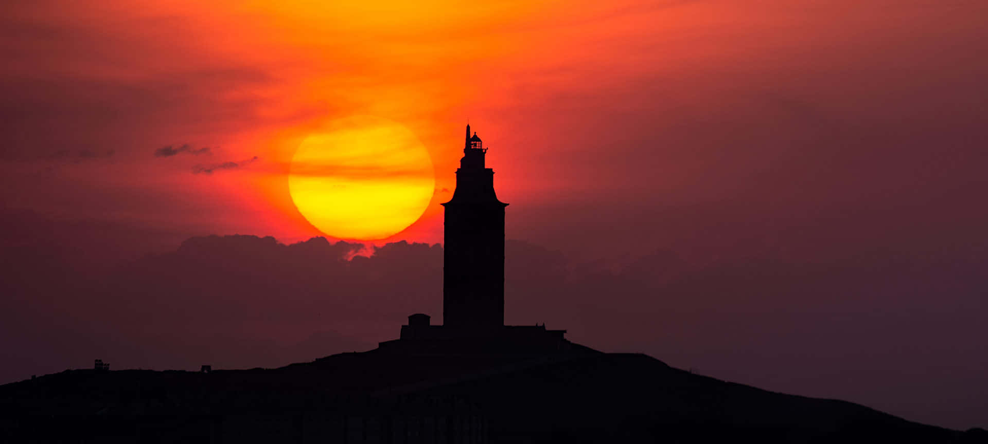 Red Aesthetic Sunset With Tower Of Hercules Wallpaper