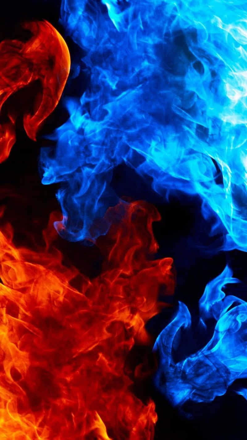 Bold flames burst in a fiery array of striking red and blue colors Wallpaper