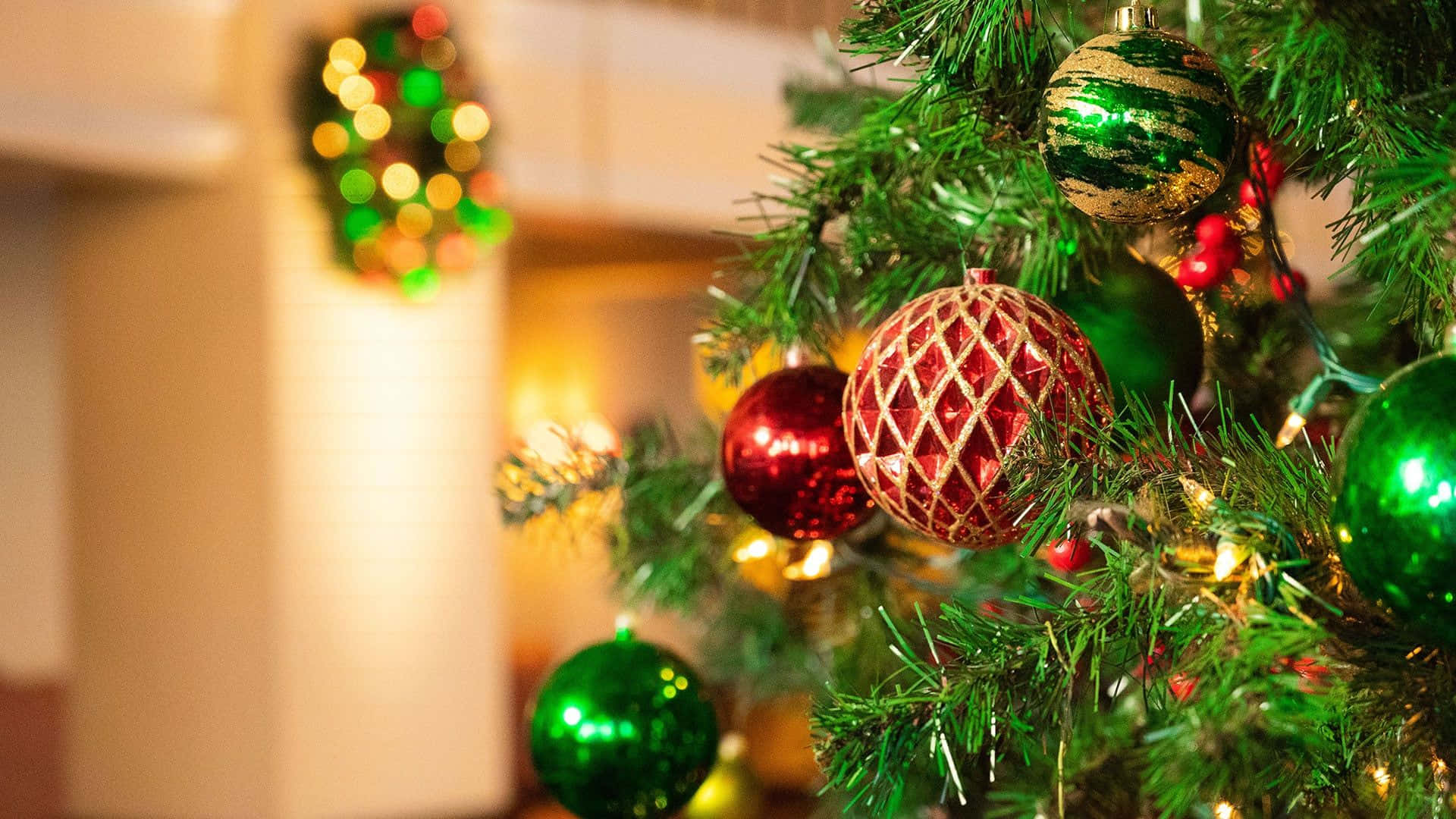 A Christmas Tree Decorated With Ornaments And Lights Wallpaper
