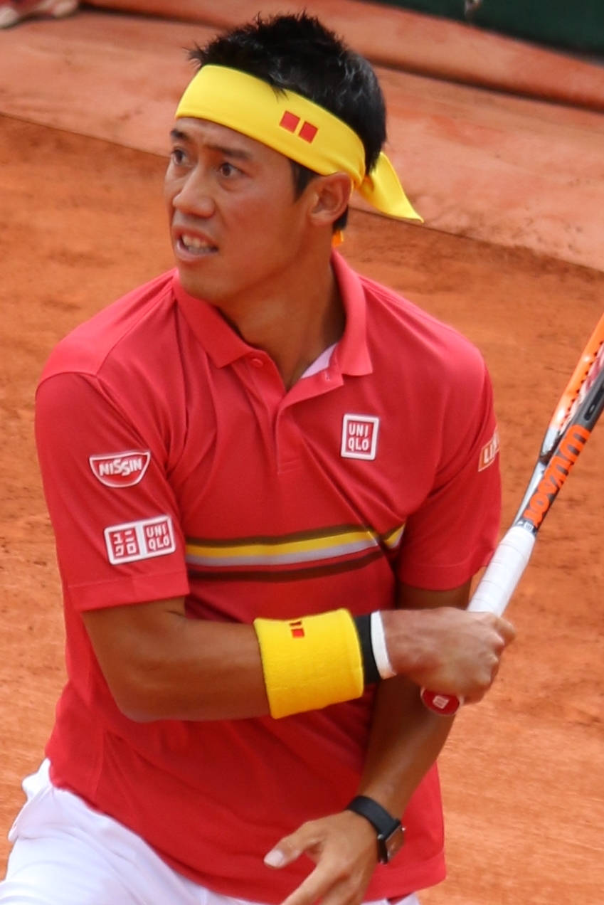 A Man Holding A Tennis Racket Wallpaper