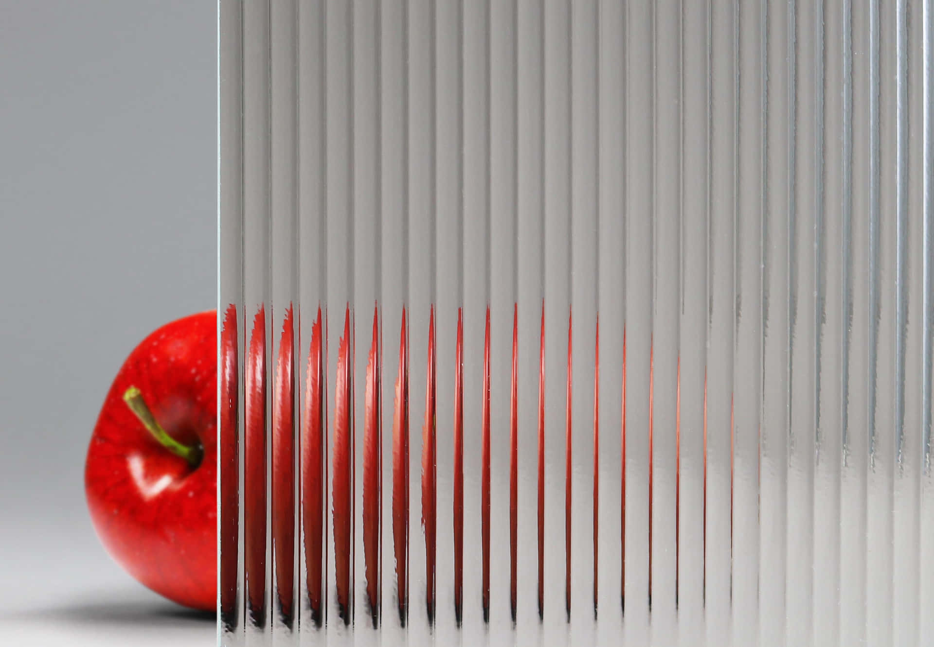 Red Apple Behind Ribbed Glass Texture Wallpaper