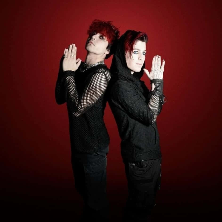 Red Backdrop Duo Pose Wallpaper