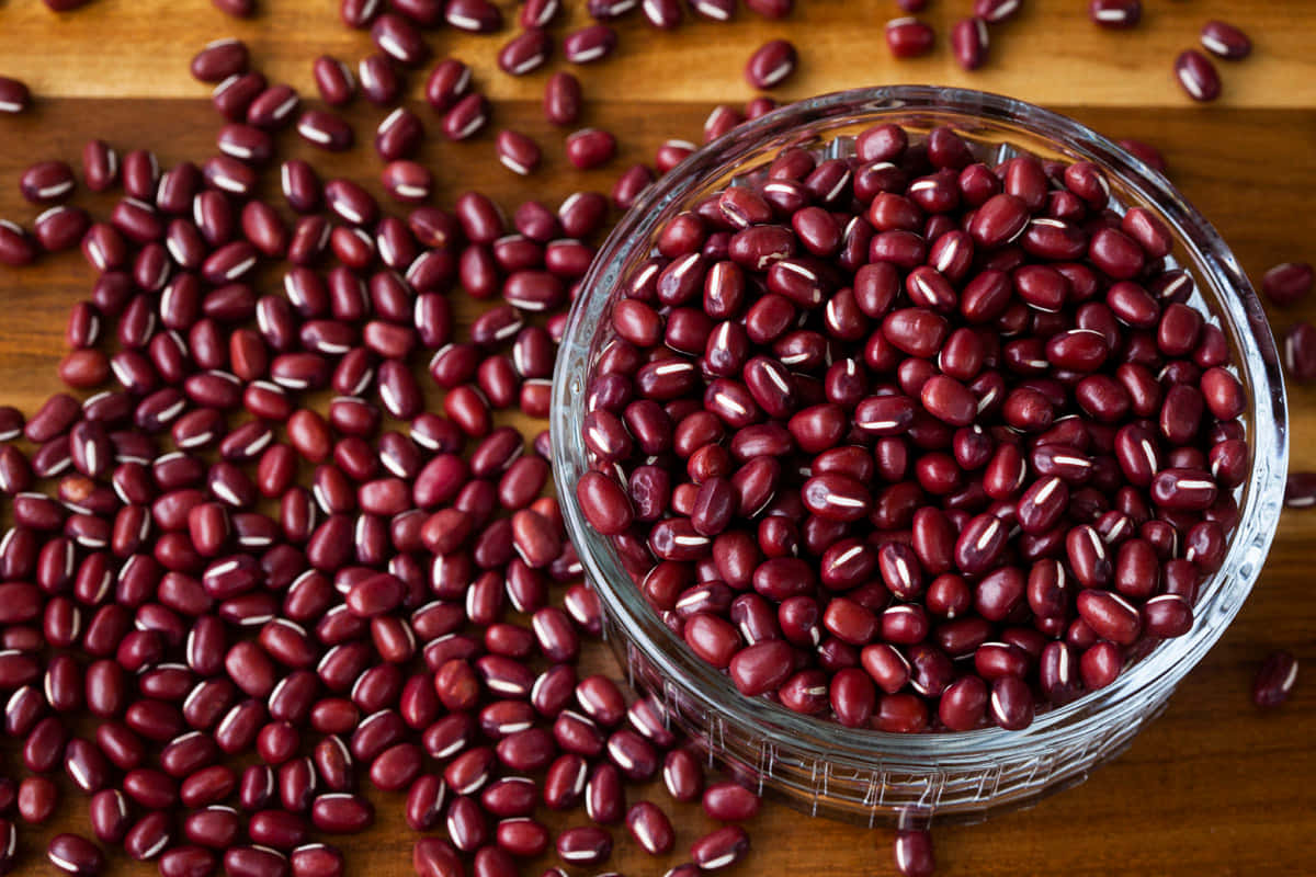 A close-up view of vibrant red beans in a bowl Wallpaper