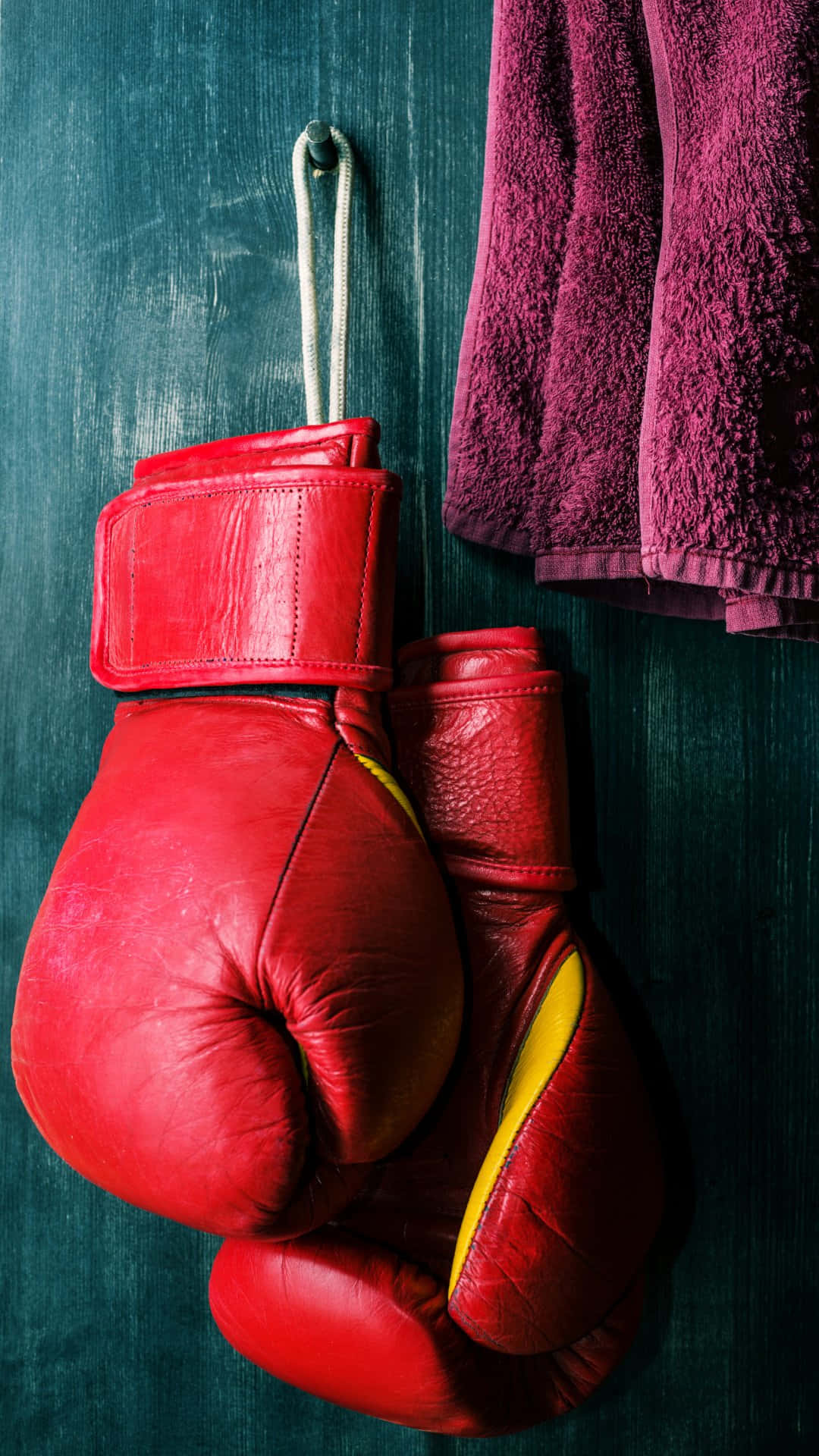 Red Boxing Gloves Hanging Beside Towel Wallpaper