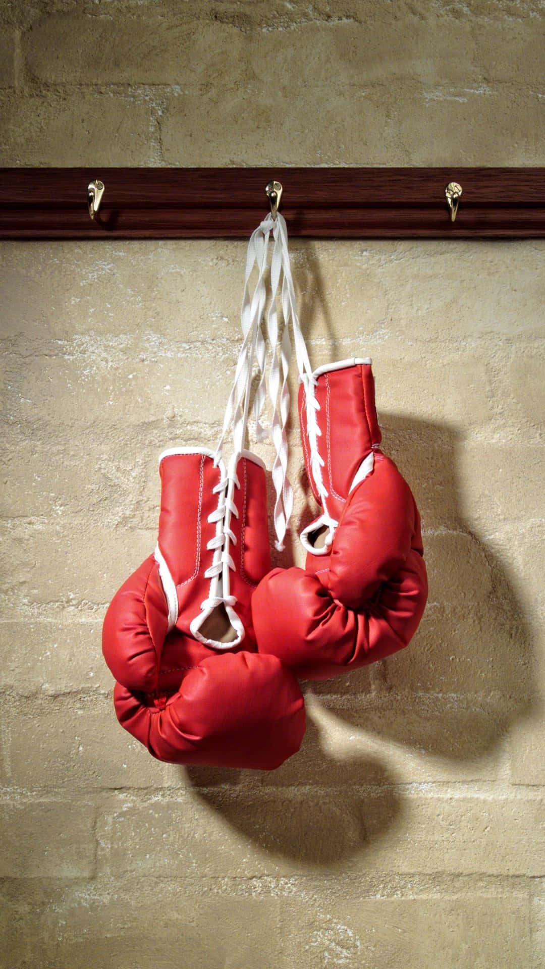 Red Boxing Gloves Hangingon Wall Wallpaper
