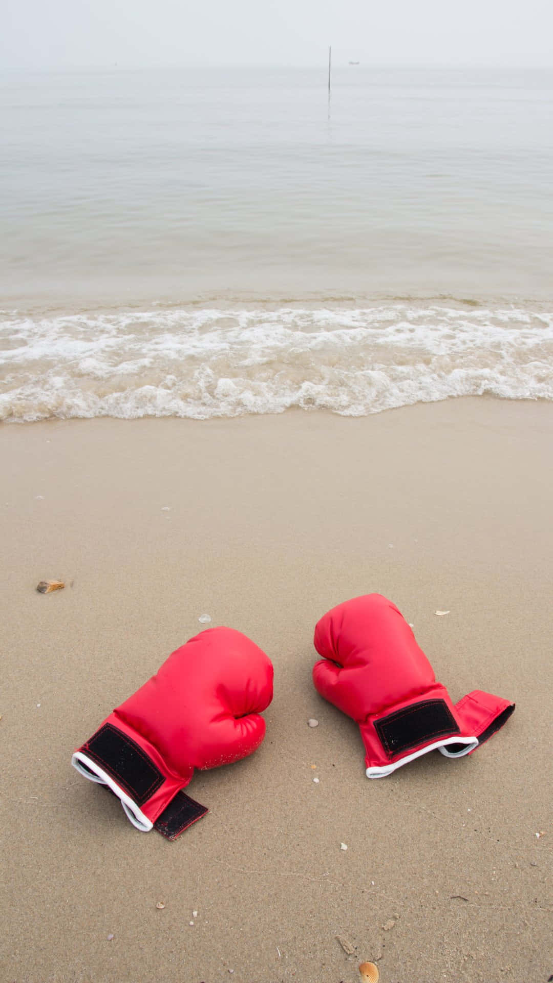 Red Boxing Gloveson Beach Sand Wallpaper