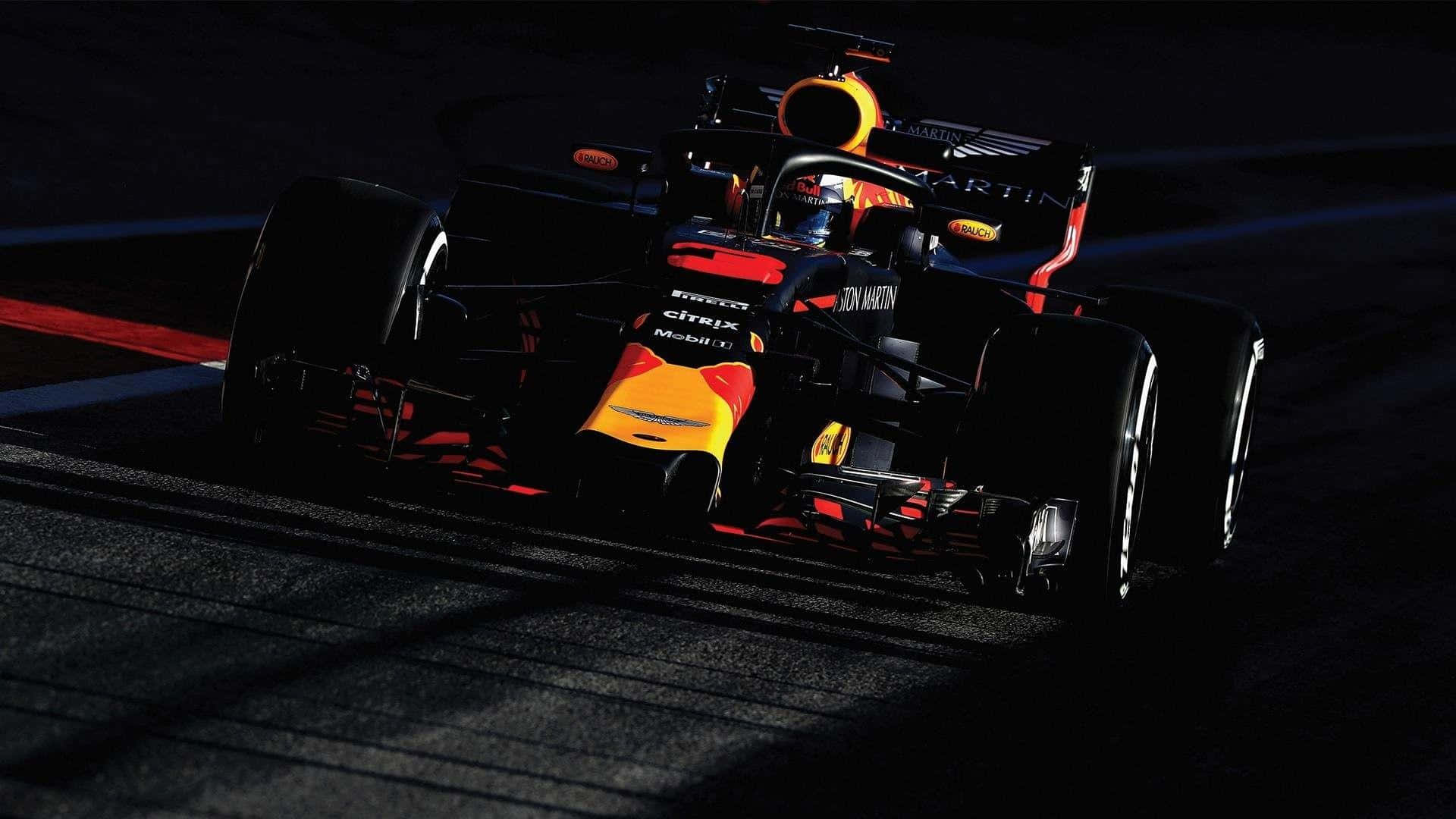 A Red Bull Racing Car Is Driving On A Track