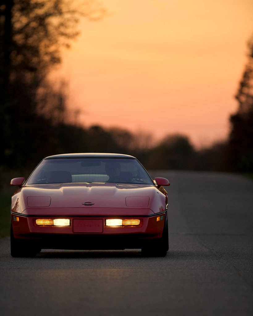 Red C4 Corvette Under The Sunset Wallpaper