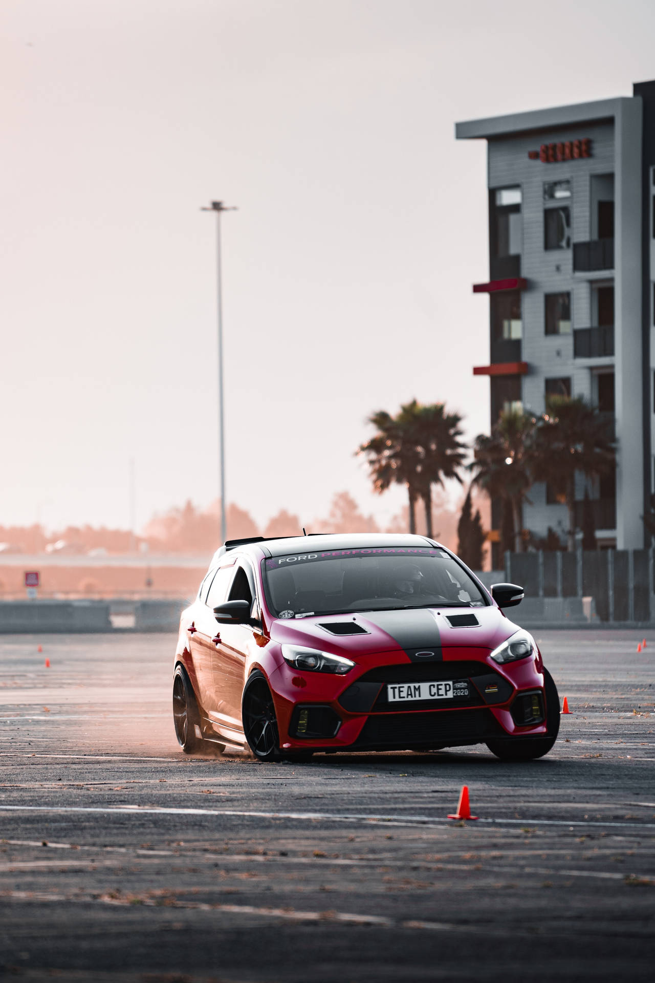 Maneuvering a Red Car in Action Wallpaper