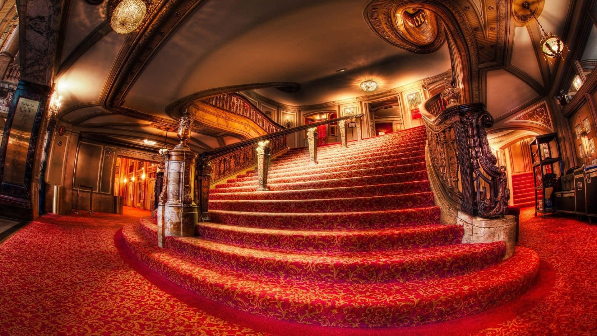 A Staircase With Red Carpet And Ornate Decorations Wallpaper