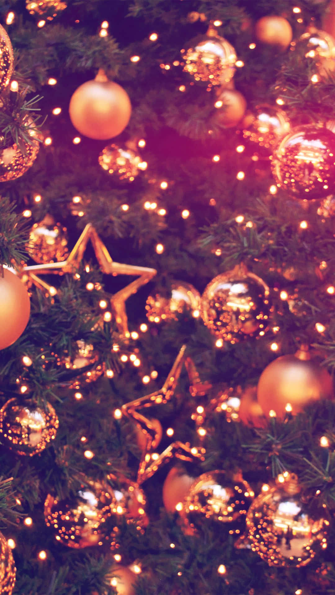 A Christmas Tree With Gold Ornaments And Stars Wallpaper