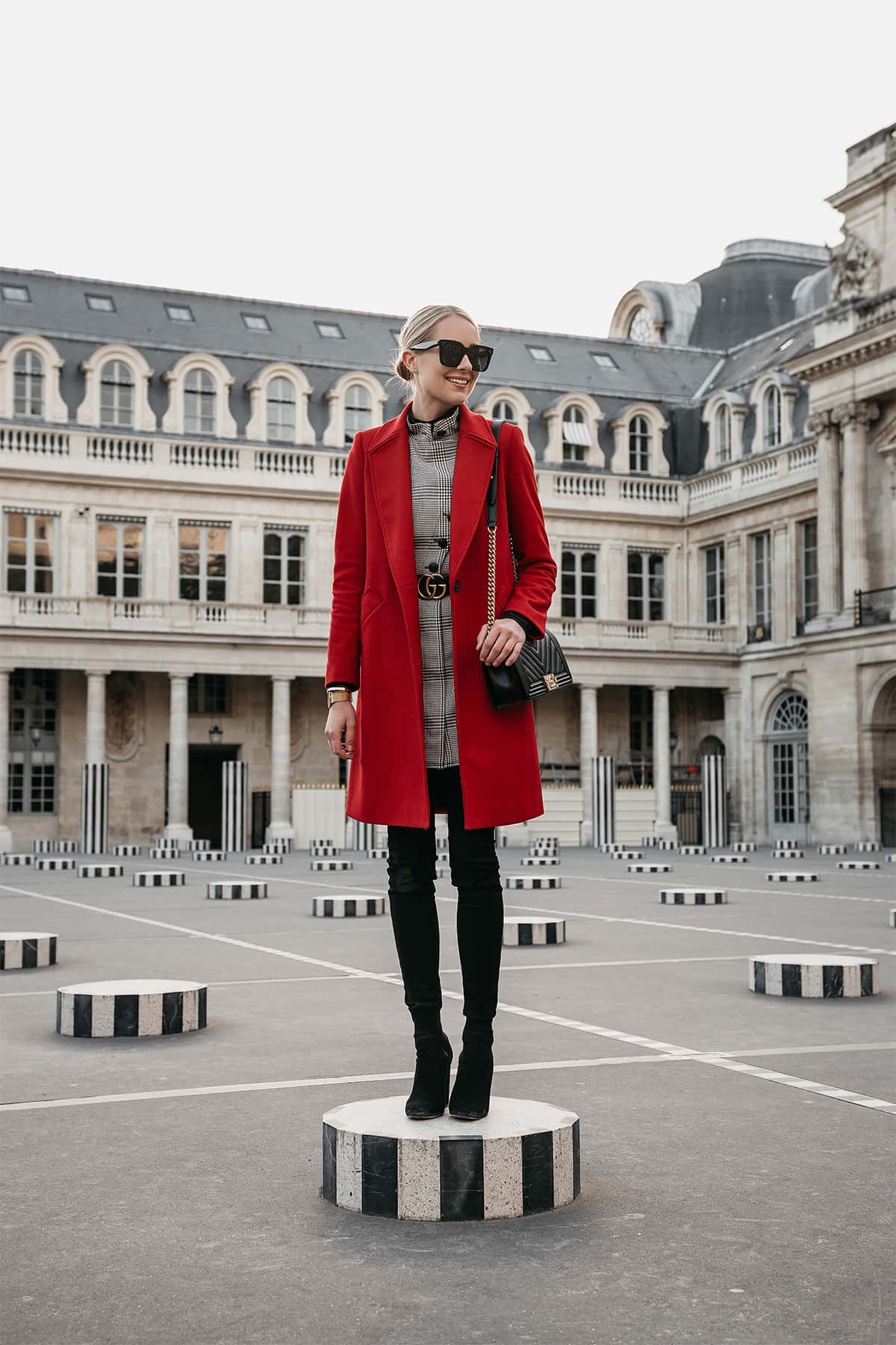Fashionable woman in a red coat at the park Wallpaper
