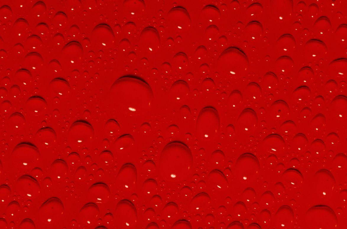 Superficiede Color Rojo Con Gotas. Fondo de pantalla