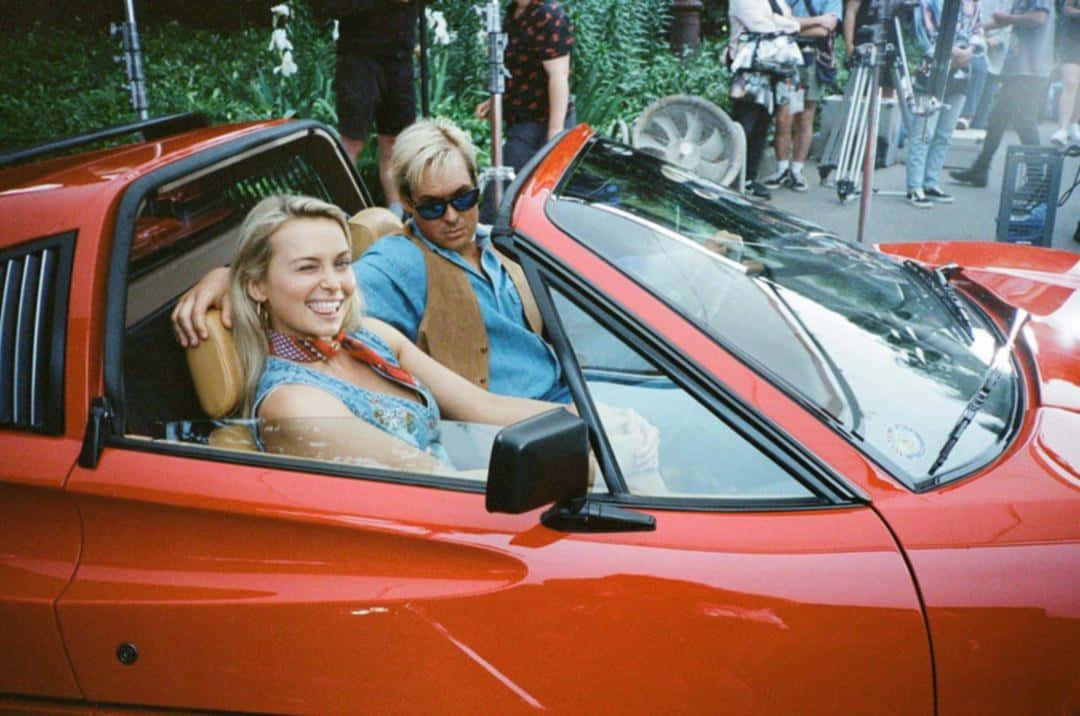 Red Convertible Ridewith Friends Wallpaper