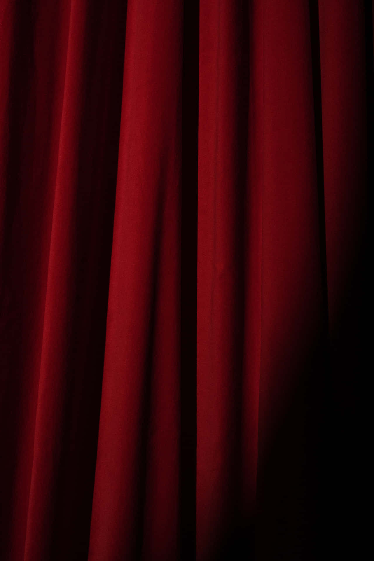 Dramatic presentation of a red velvet curtain