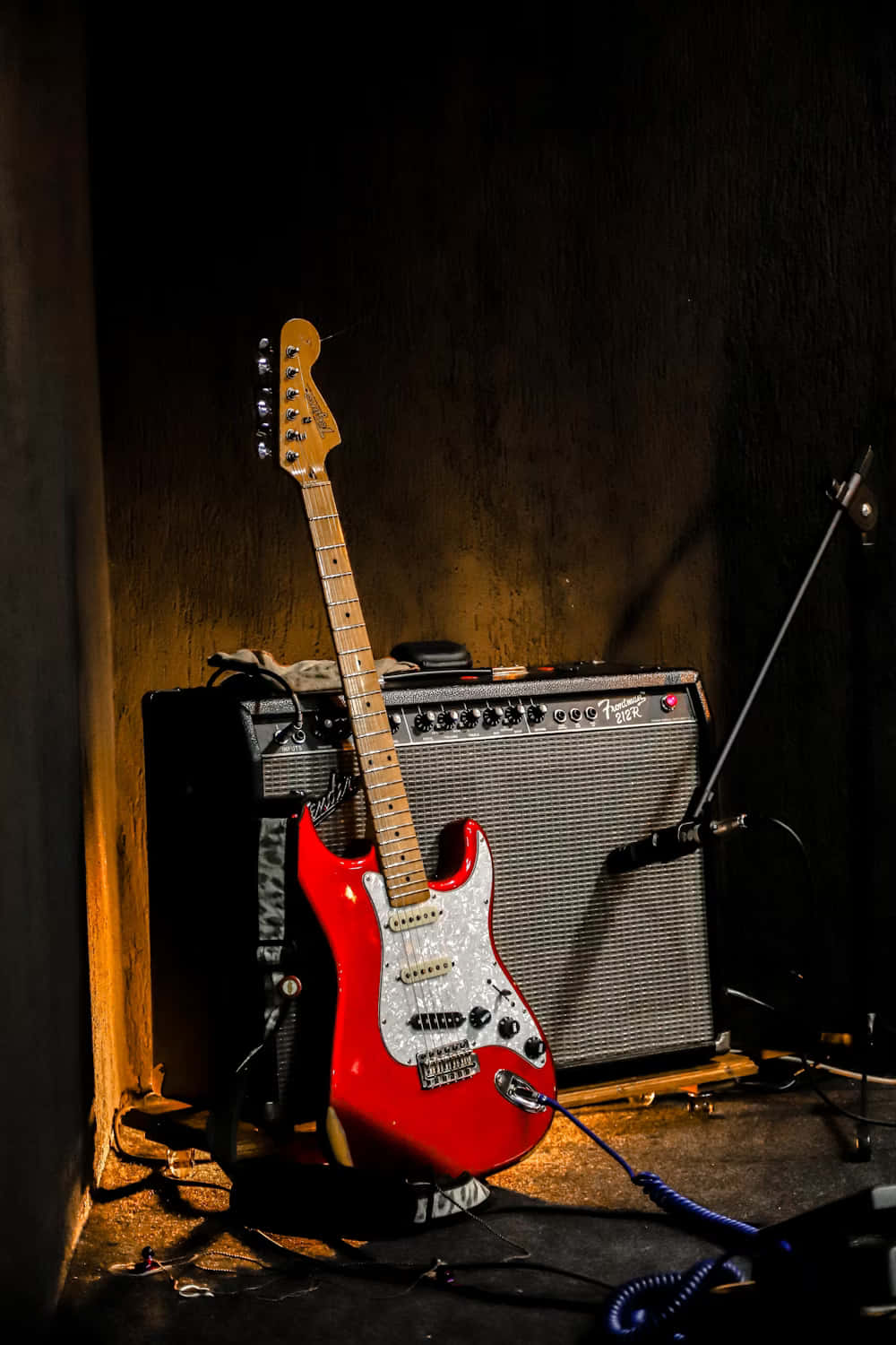 Red Electric Guitarand Amplifier Stage Setup Wallpaper
