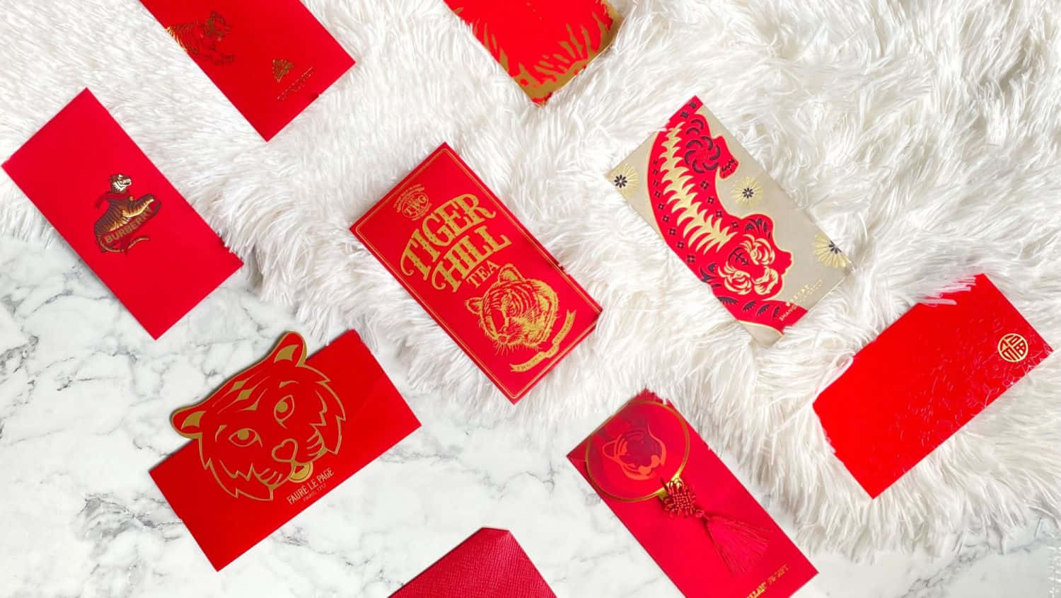 A red envelope beautifully adorned with elegant golden designs Wallpaper