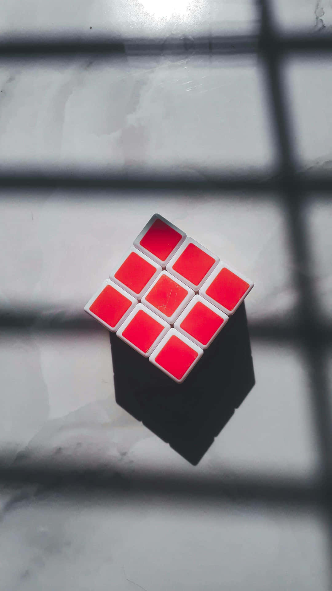 Red Faced Rubiks Cubeon Shadowed Background.jpg Wallpaper