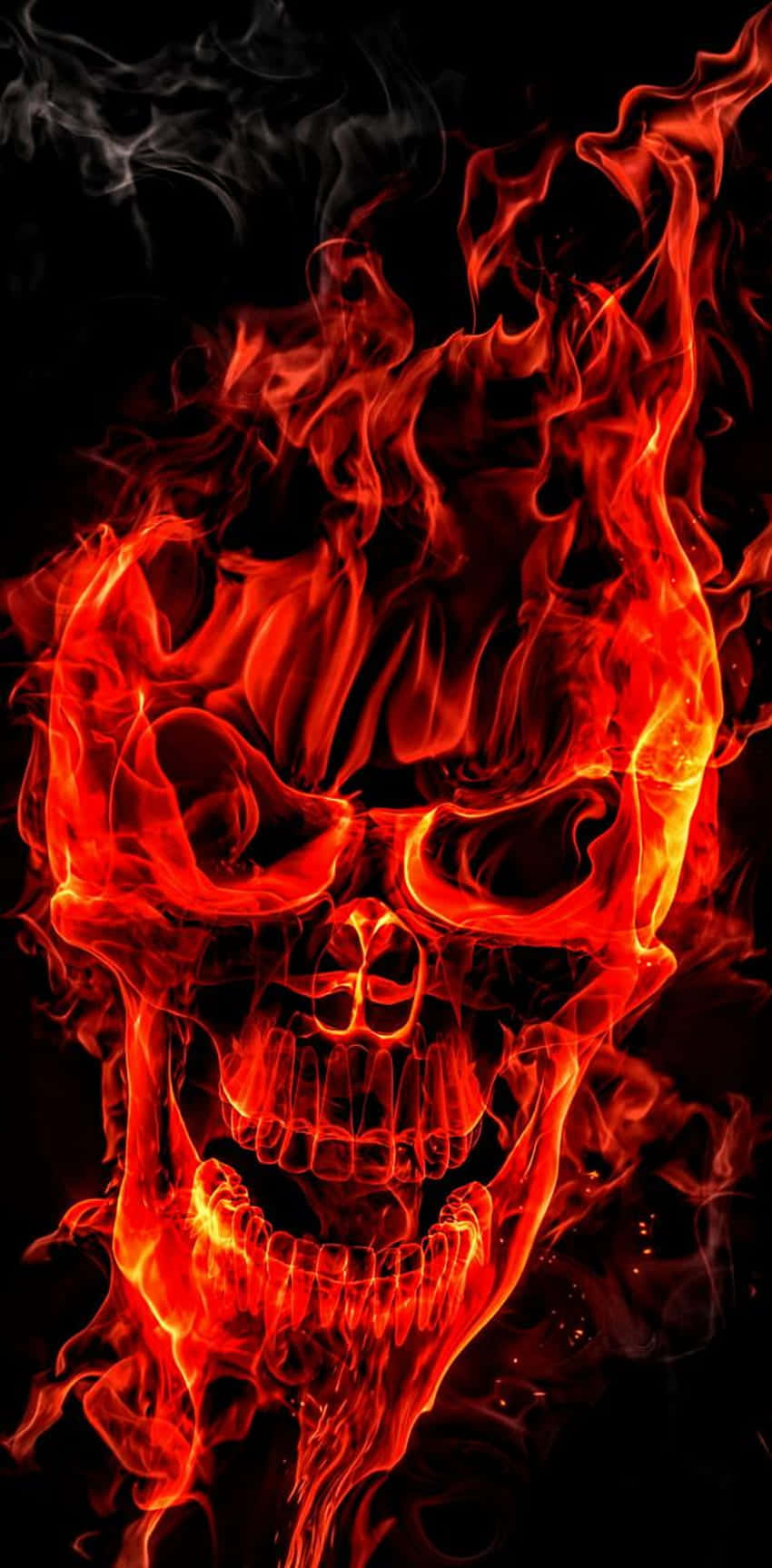 A Flaming Skull Fills the Dark with an Eerie Red Glow Wallpaper