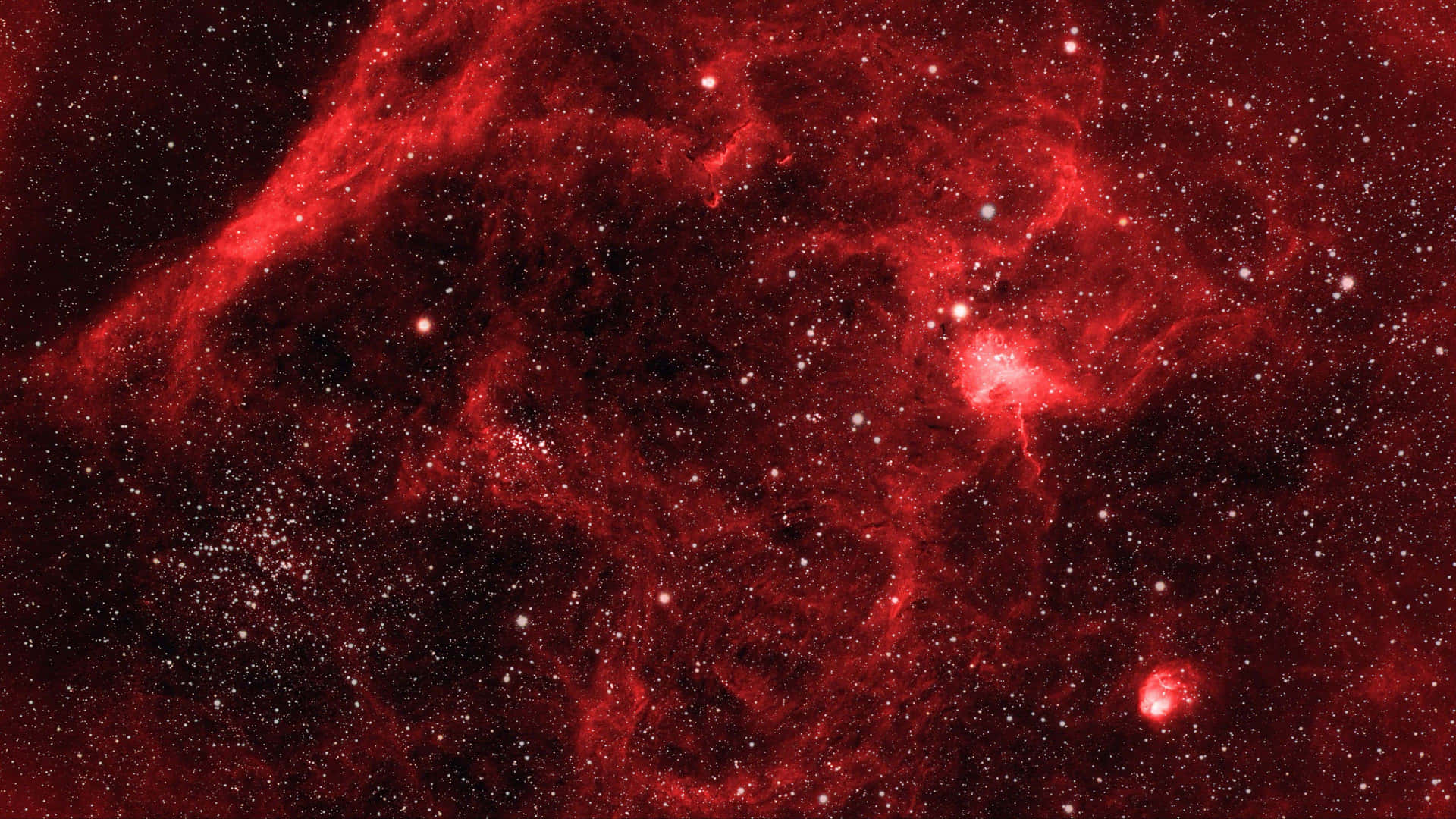 A Red Nebula With Stars In It