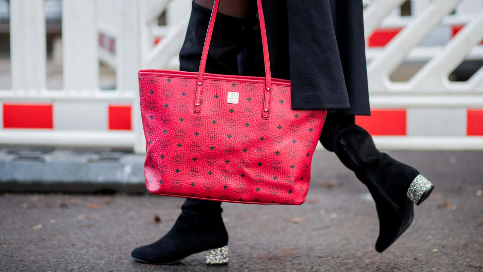 Caption: Stylish Red Handbag on a Wooden Surface Wallpaper