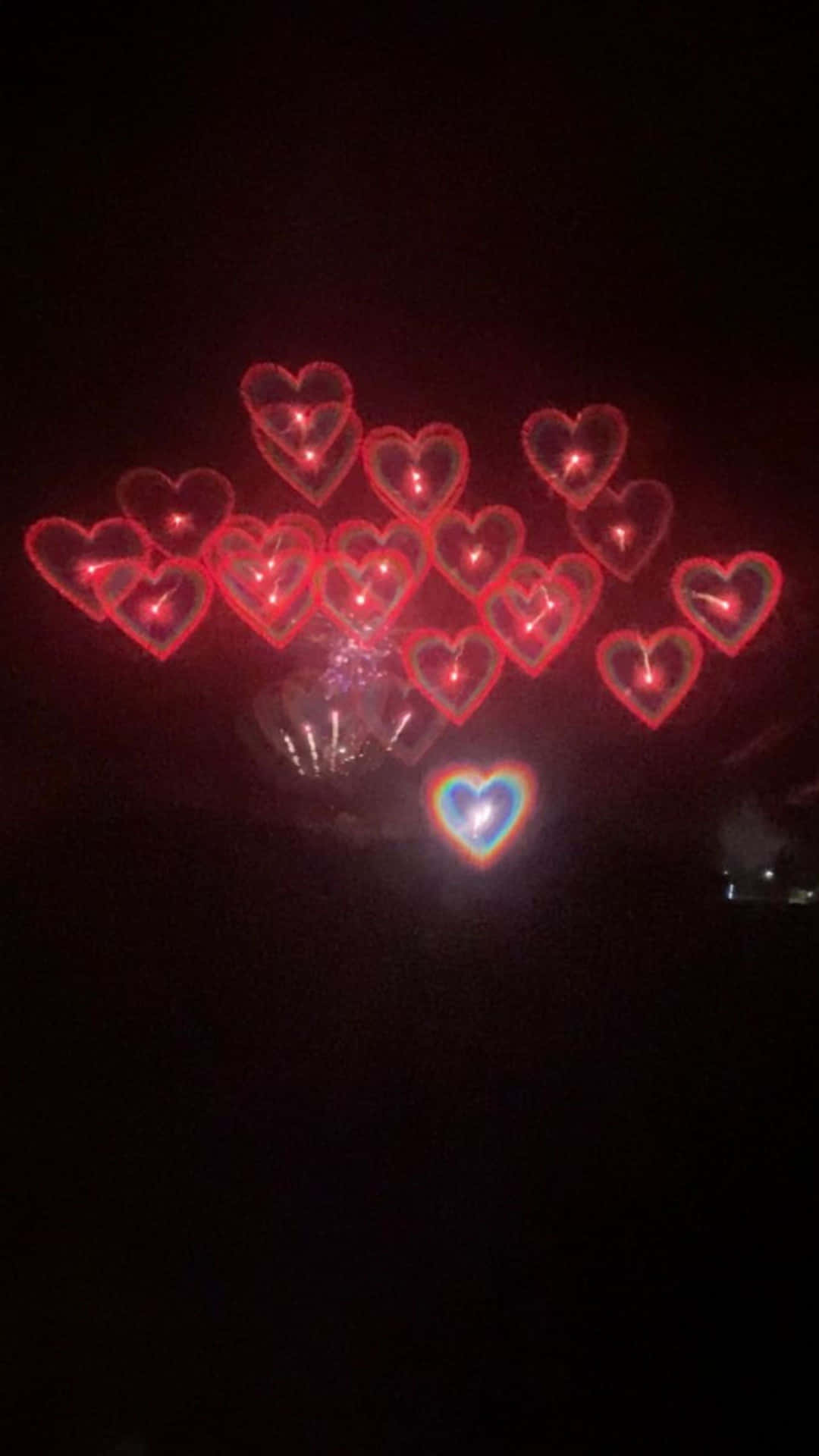 a heart shaped firework in the dark
