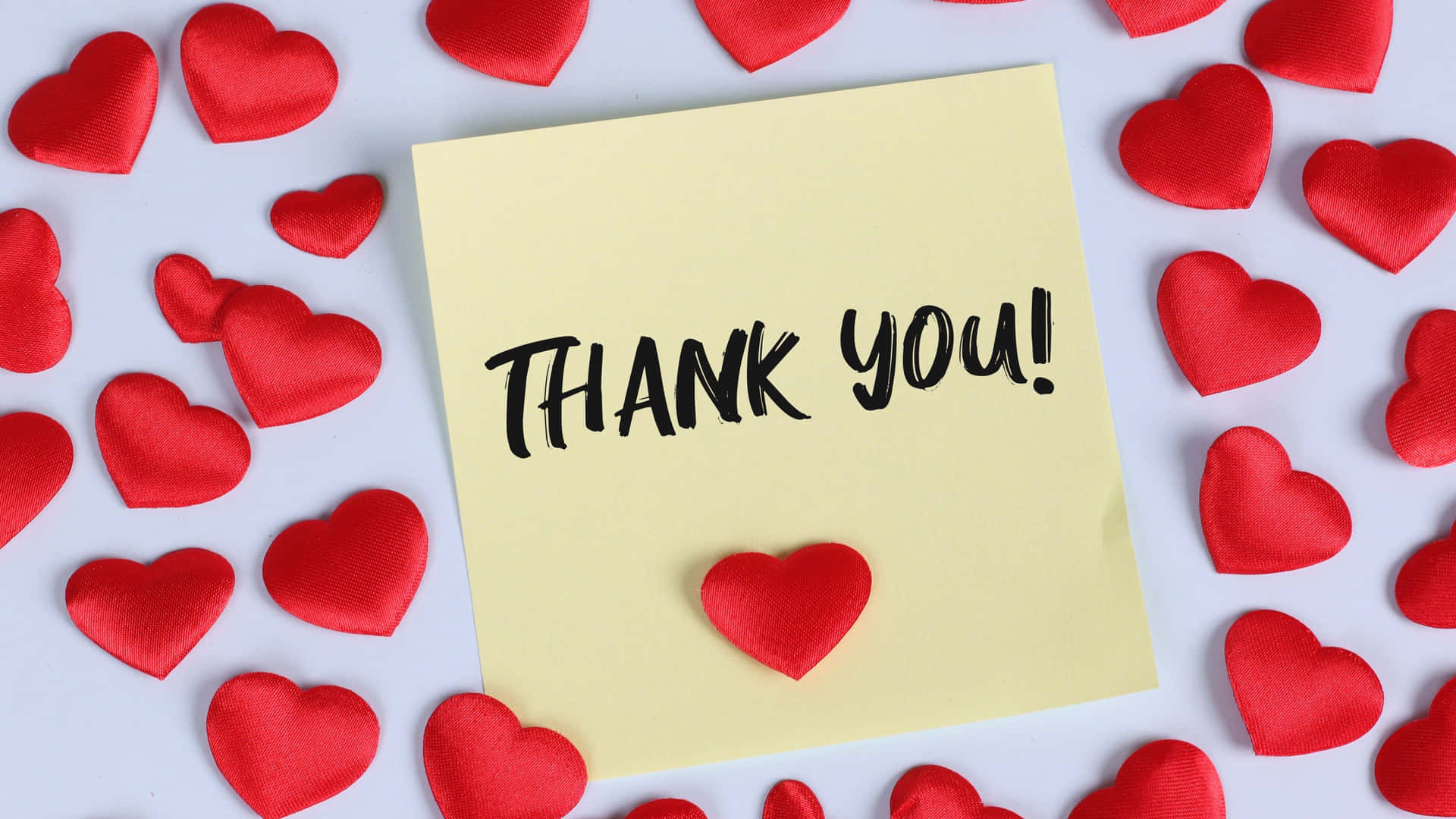 thank you note with red hearts on white background