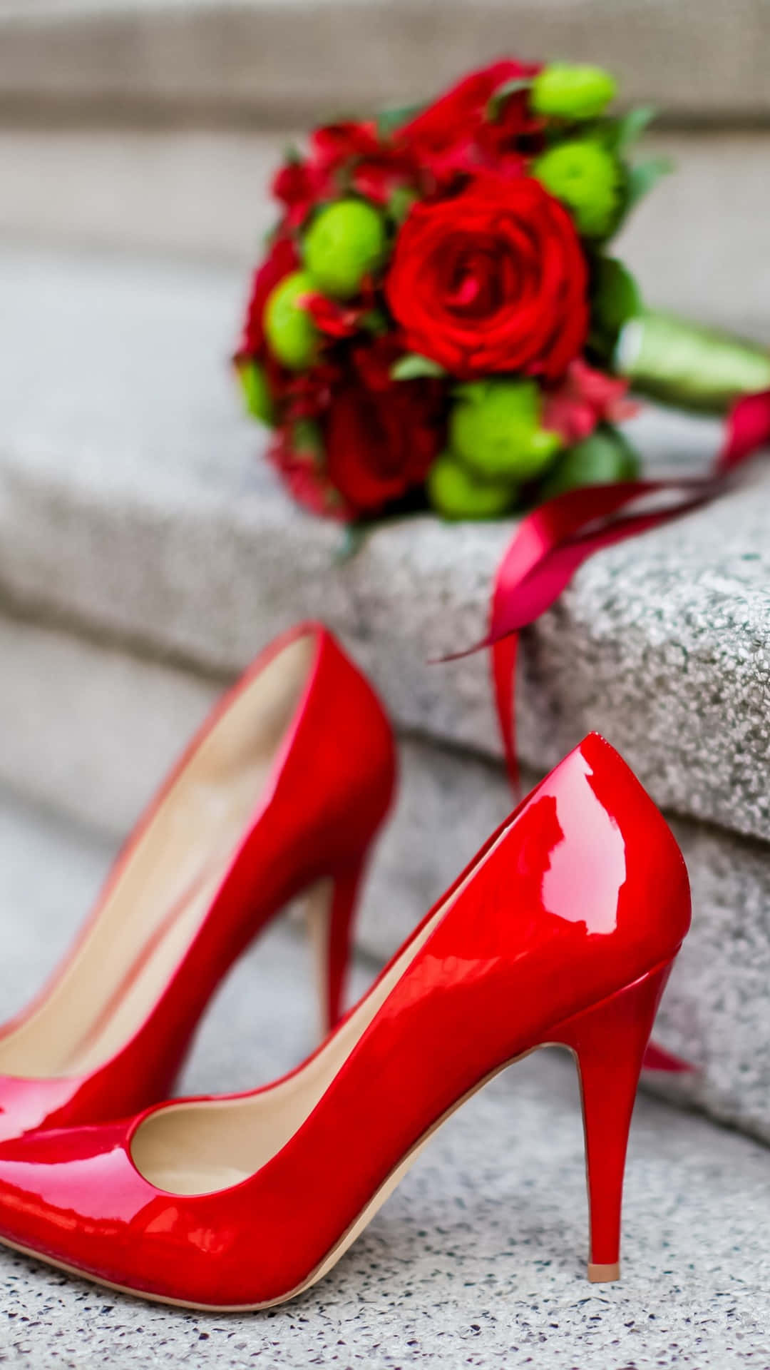 Elegant Red High Heels on a Reflective Surface Wallpaper