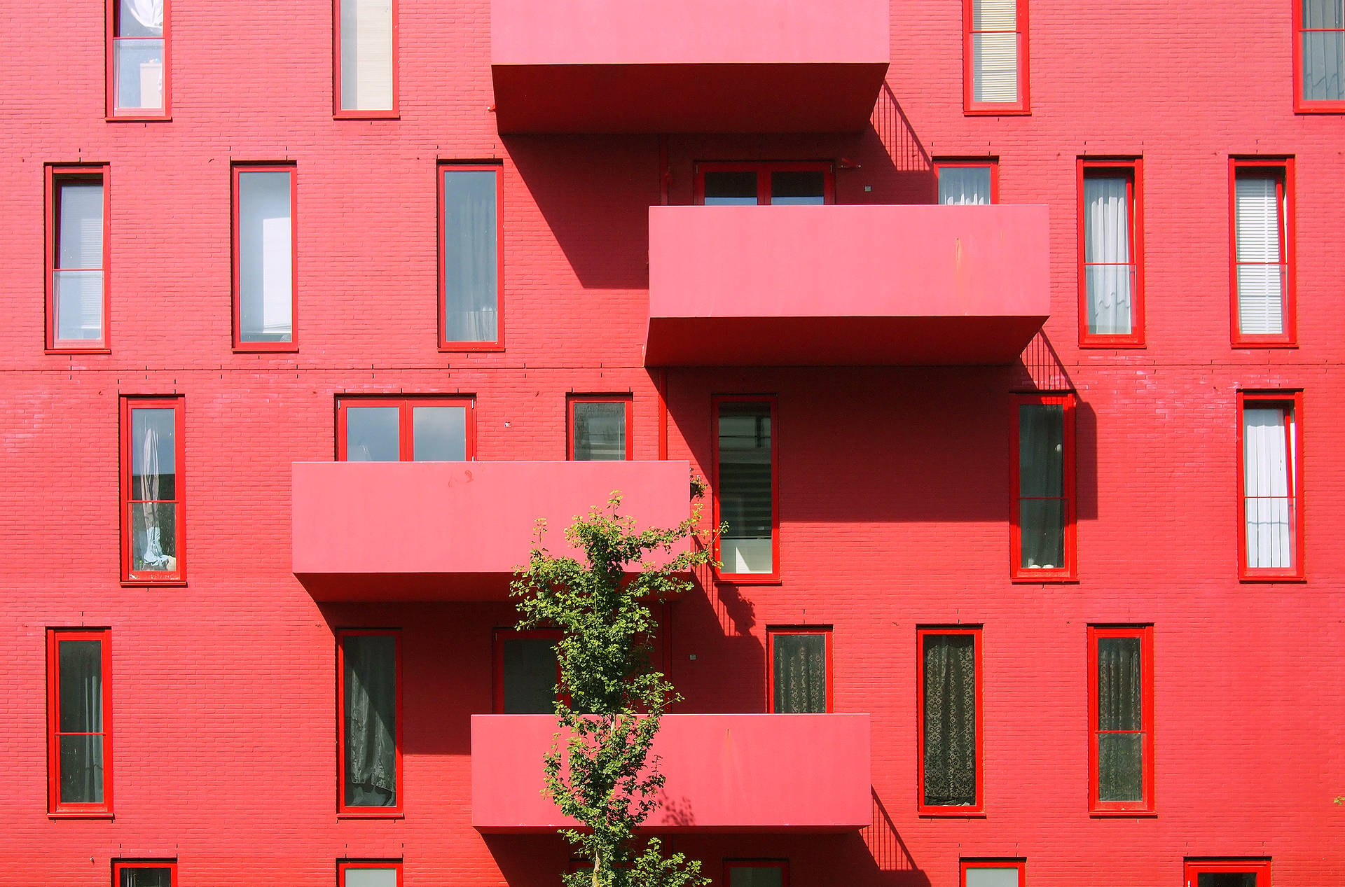Pristine Red High-Rise Building in the City Wallpaper