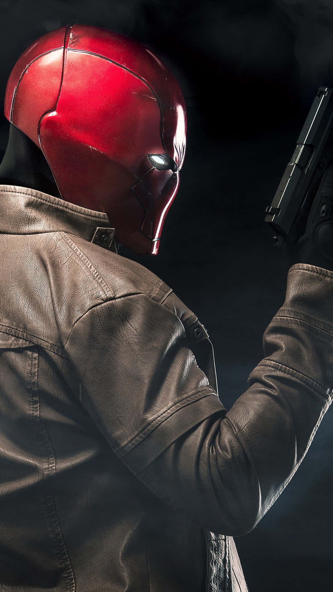 A Man In A Red Helmet Holding A Gun