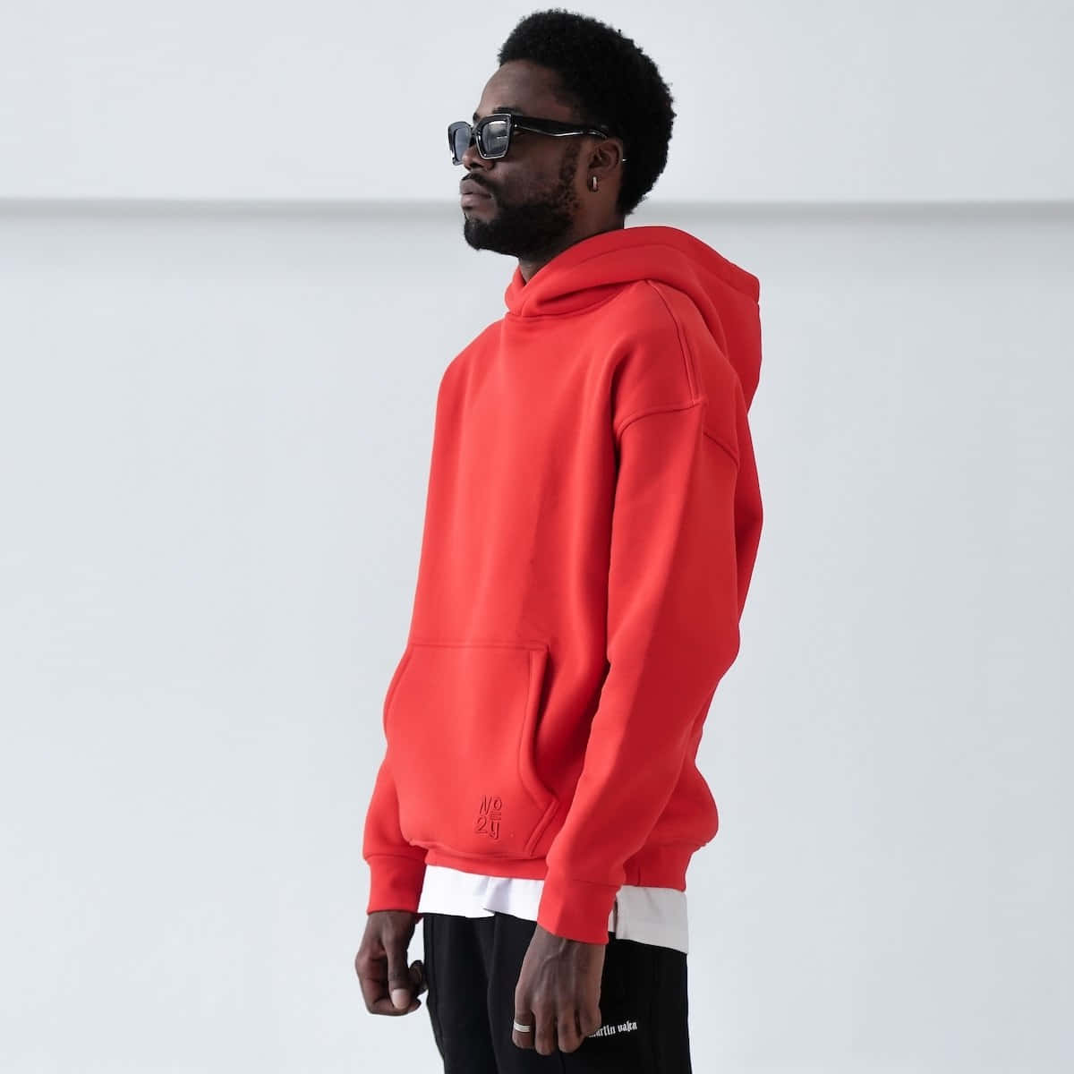 Stylish red hoodie worn by a modern individual Wallpaper