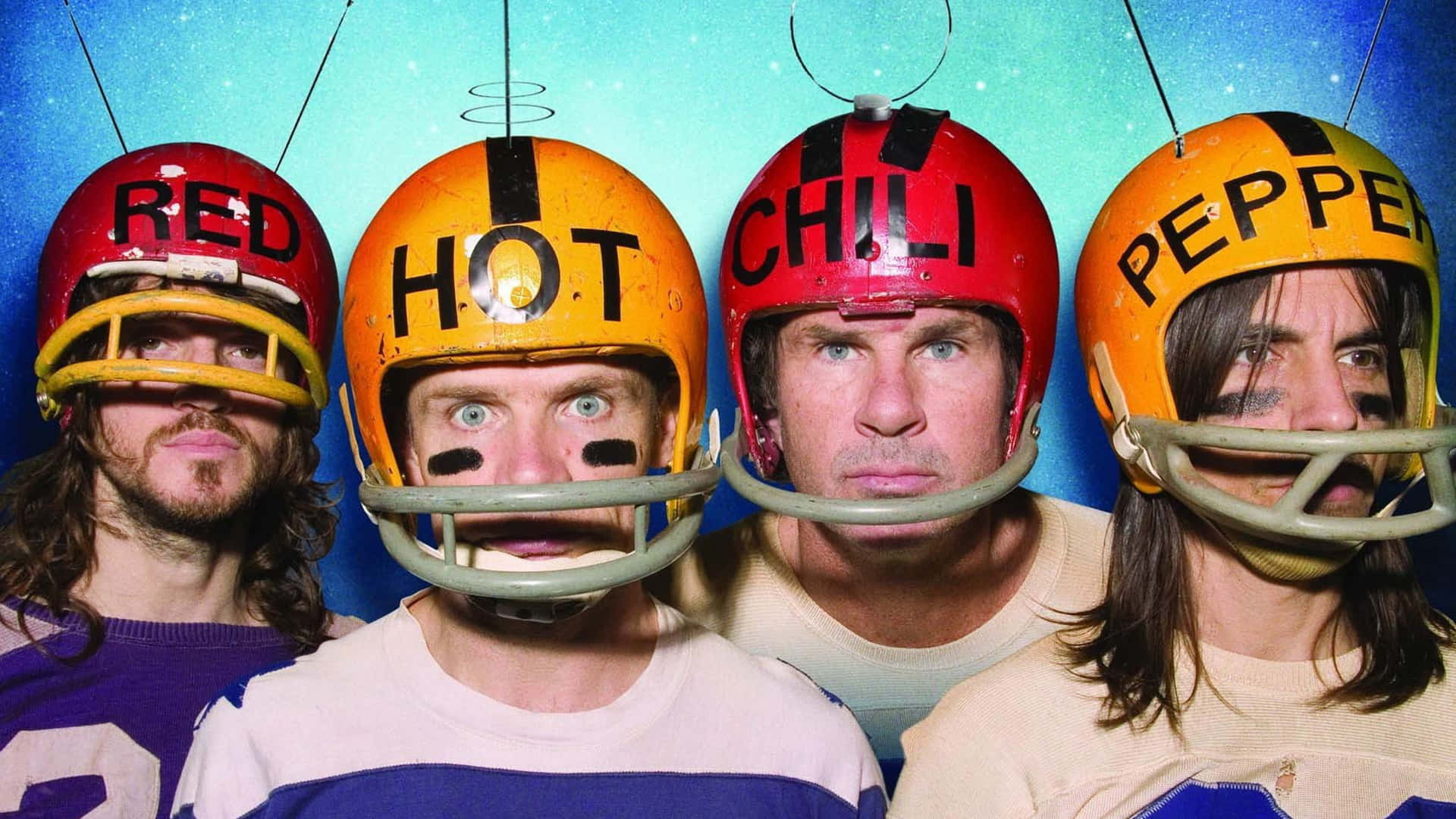 Four Men Wearing Helmets With Red, Hot, And Pepper Wallpaper