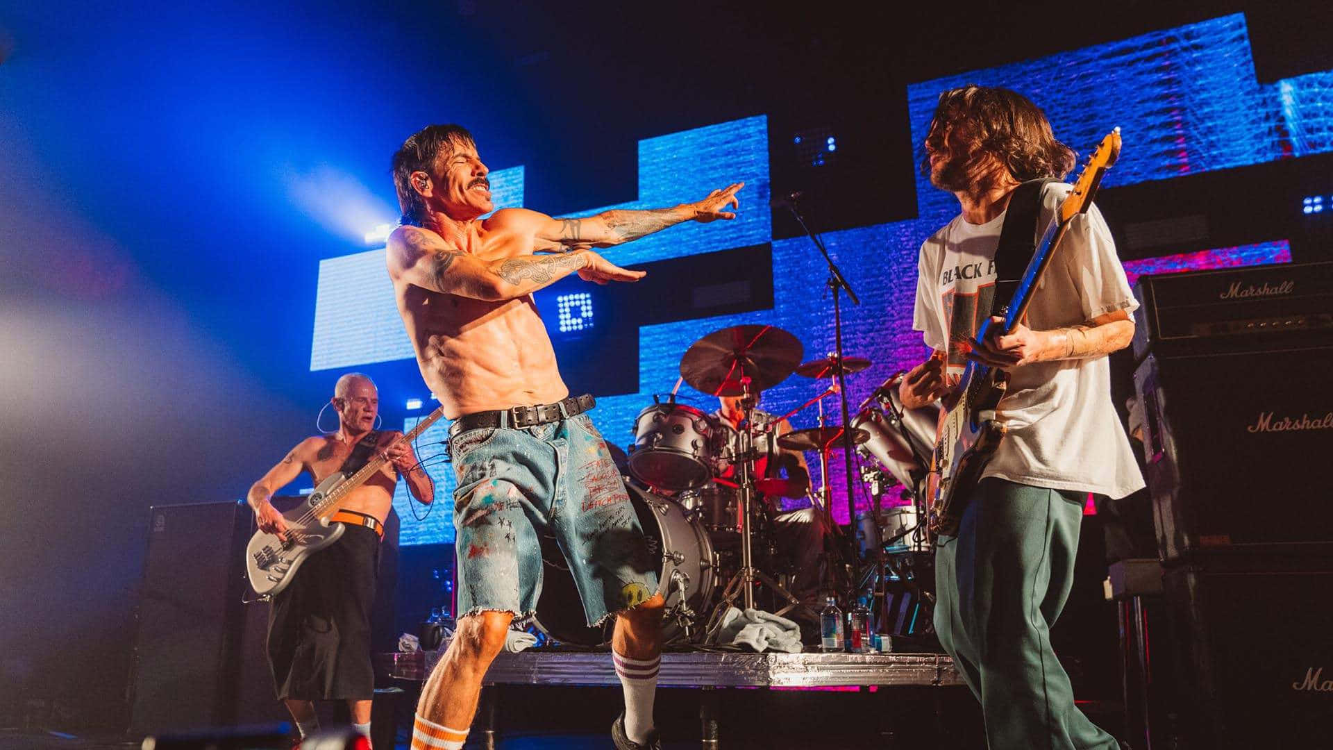 The Red Hot Chili Peppers performing together on stage Wallpaper