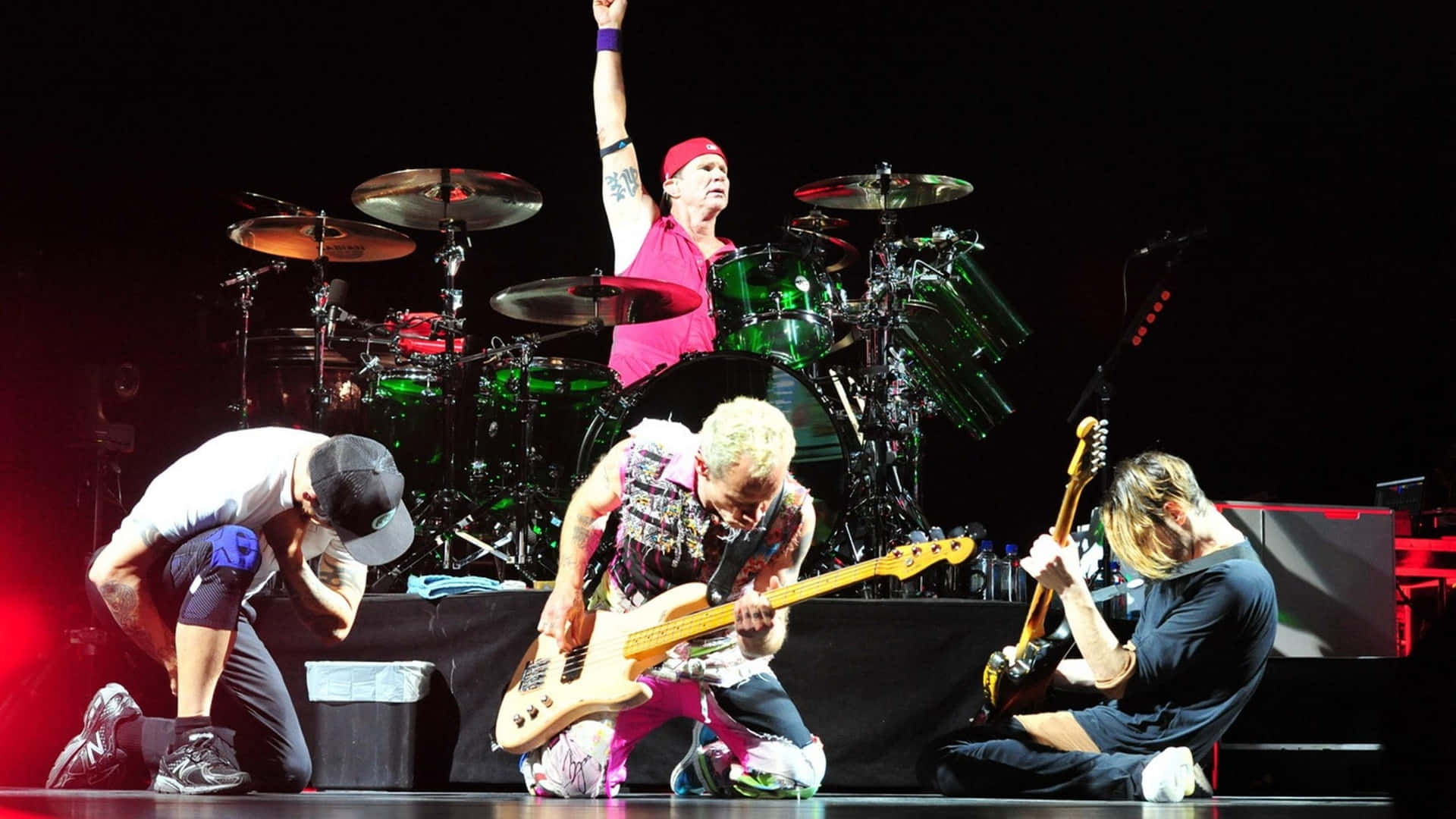 Red Hot Chili Peppers Kneeling On Stage Wallpaper