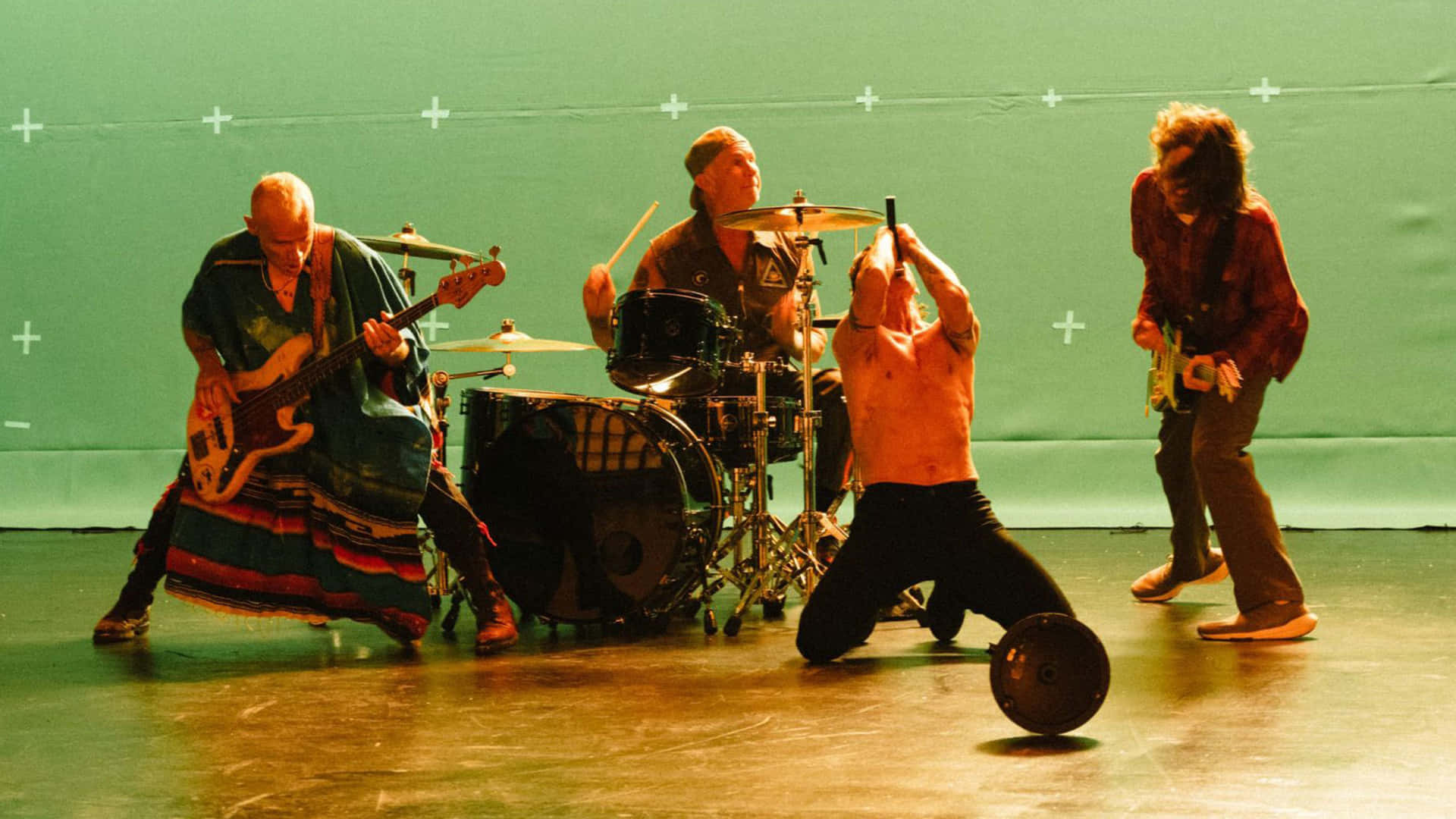 En gruppe mennesker på scenen med trommer og trommer spille Wallpaper