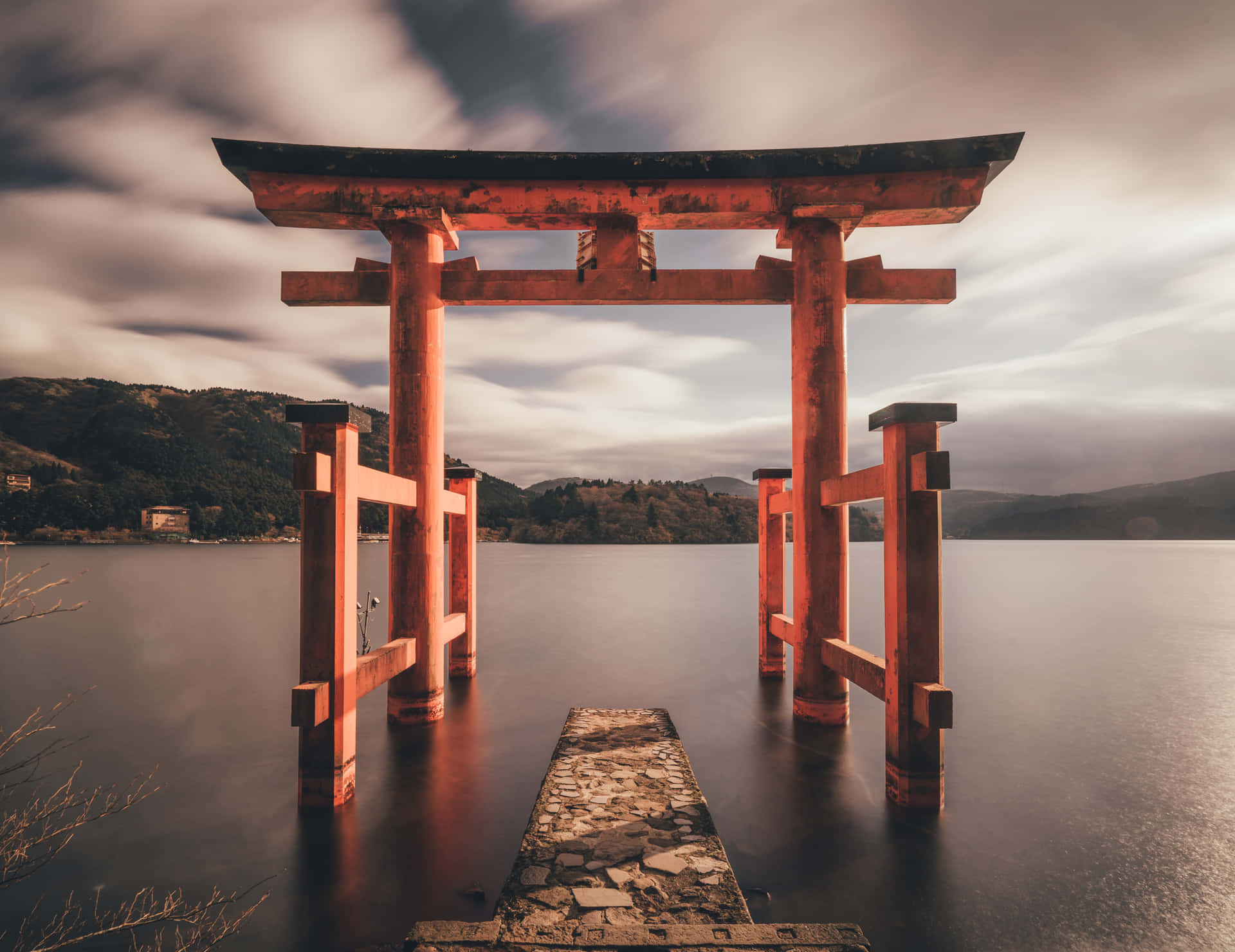 A Red Tori Gate Is Standing In The Water Wallpaper