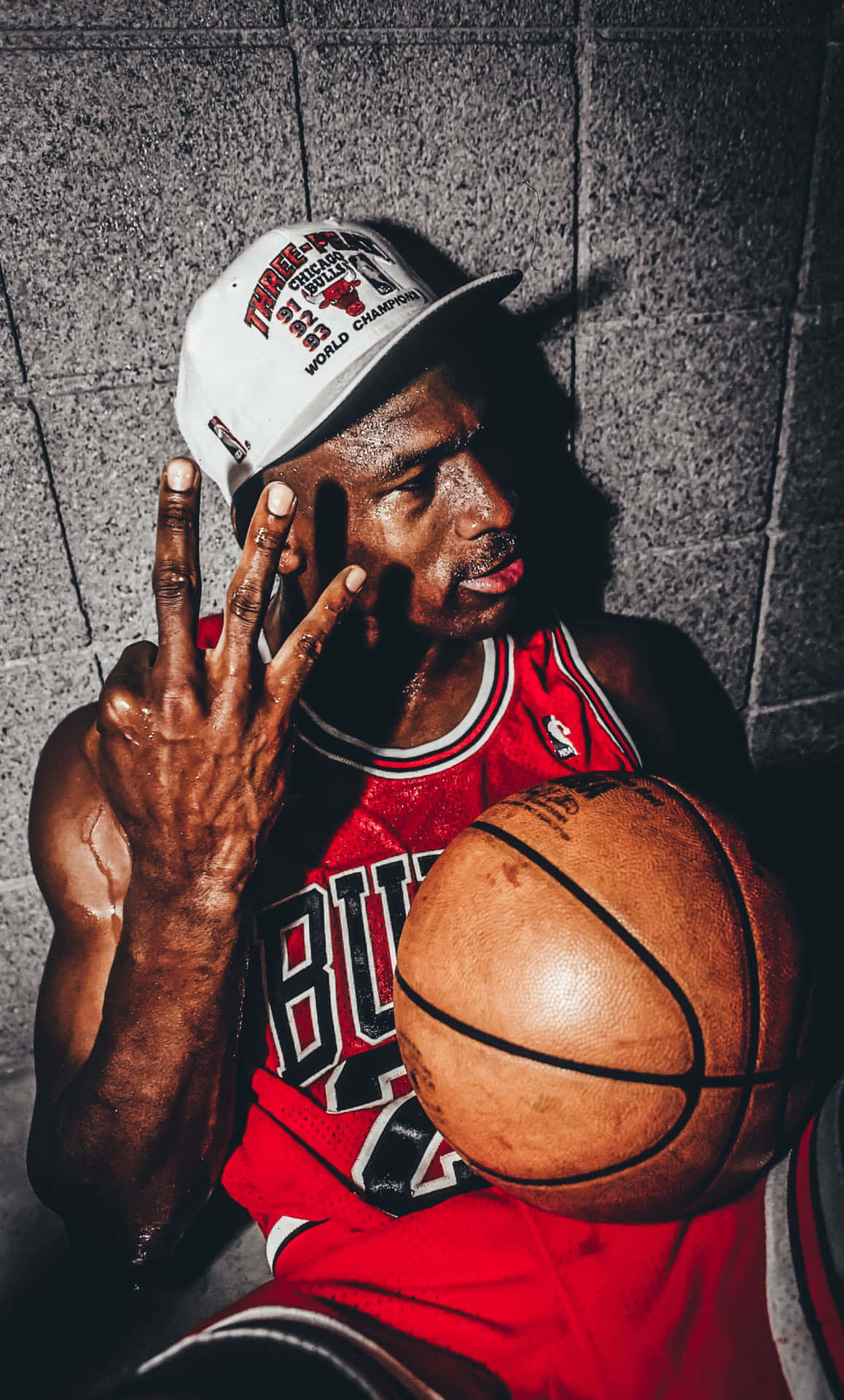 A Man Holding A Basketball With His Fingers Up Wallpaper