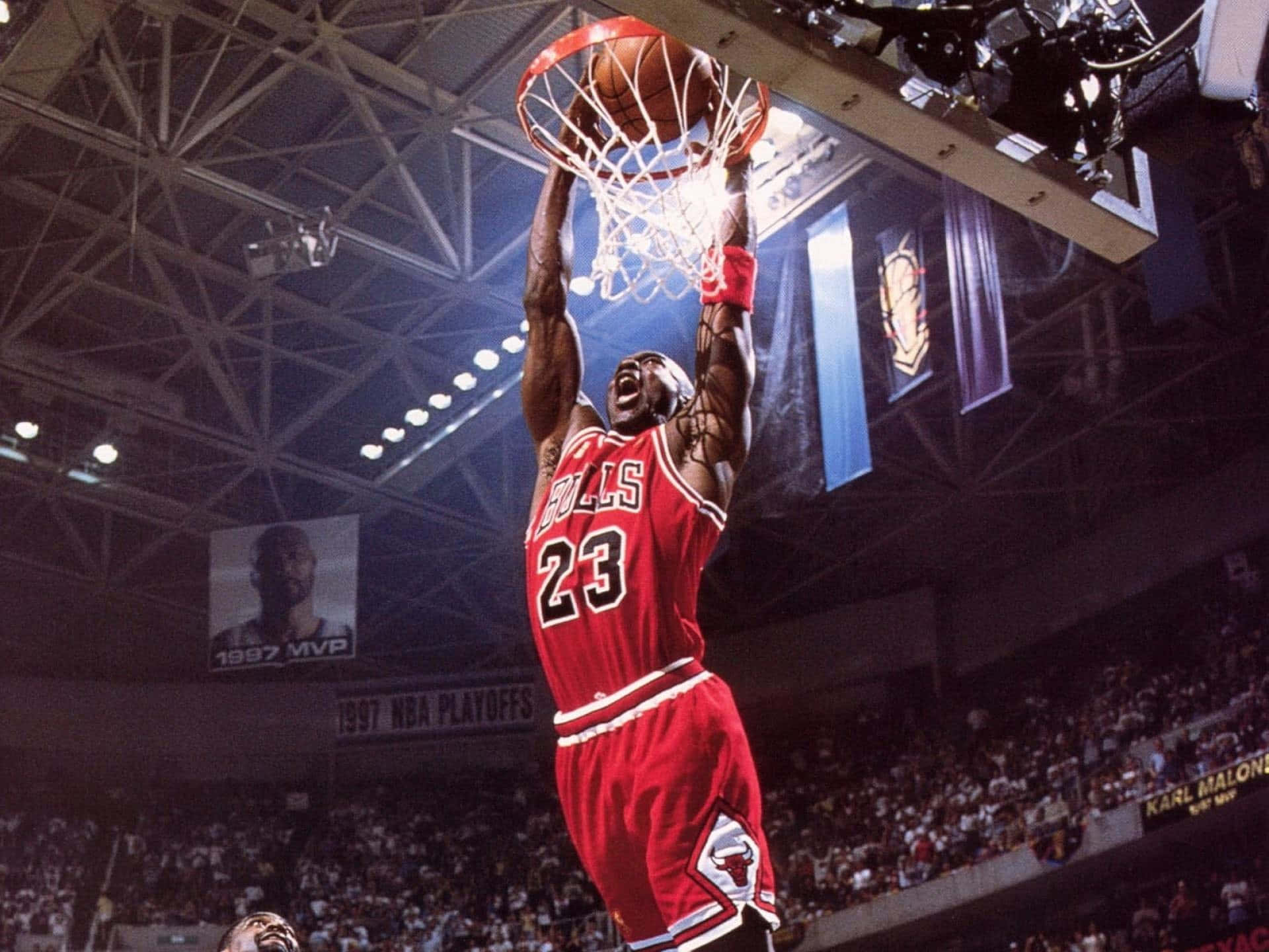 A Basketball Player Dunking The Ball In The Air Wallpaper